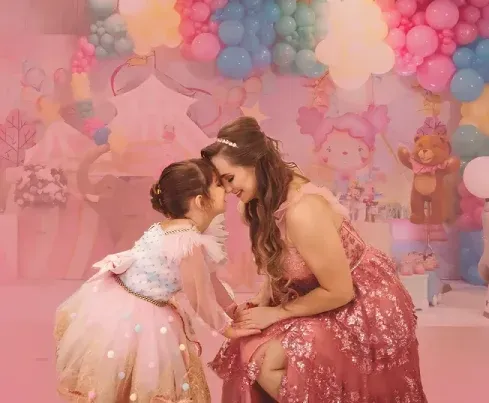 Mother and daughter sharing a tender moment at a pink circus-themed birthday party in Boca Raton