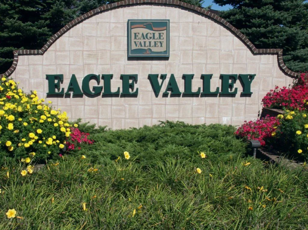 Large backyard cedar deck with railing in Eagle Valley, Woodbury