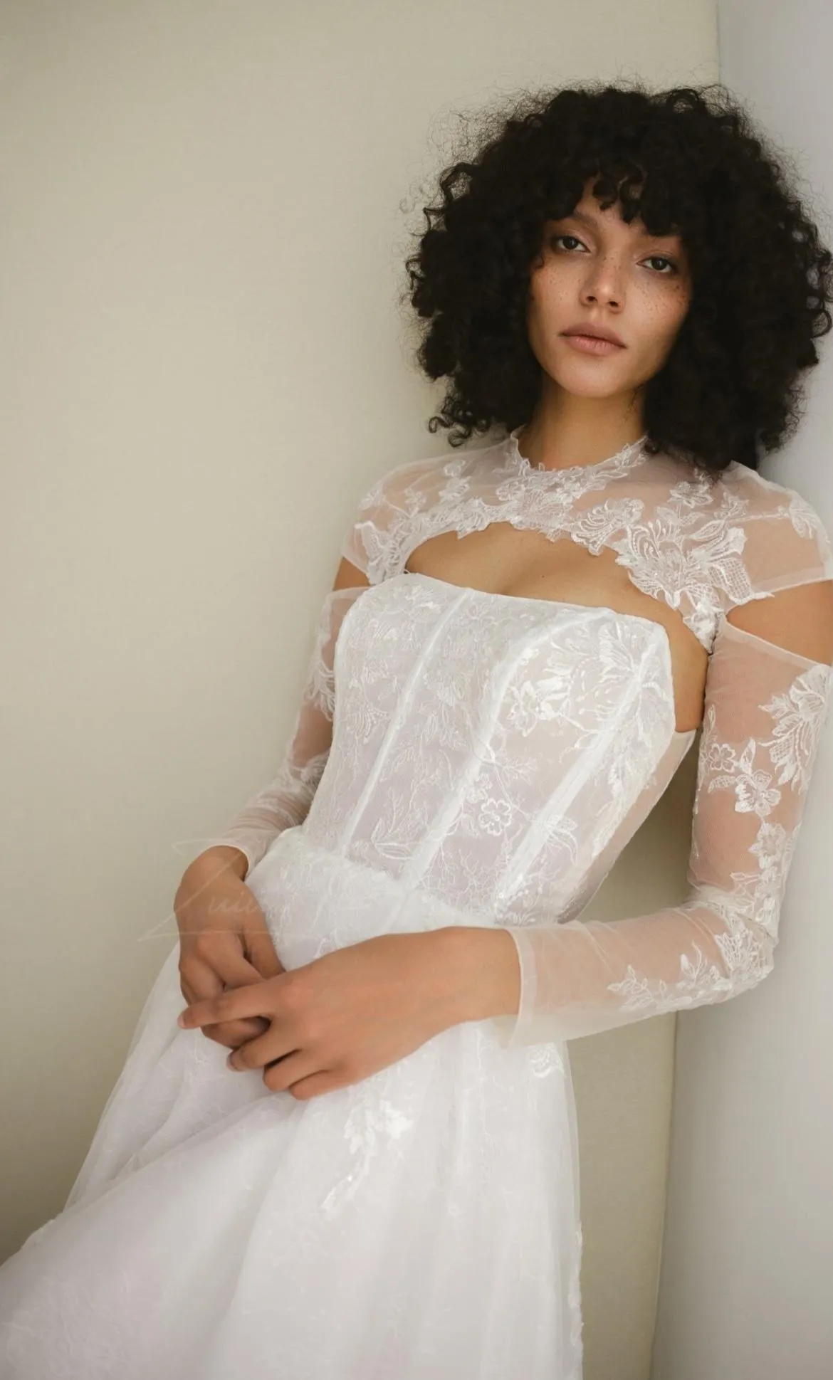 Close-up of white lace trim on sheer fabric.