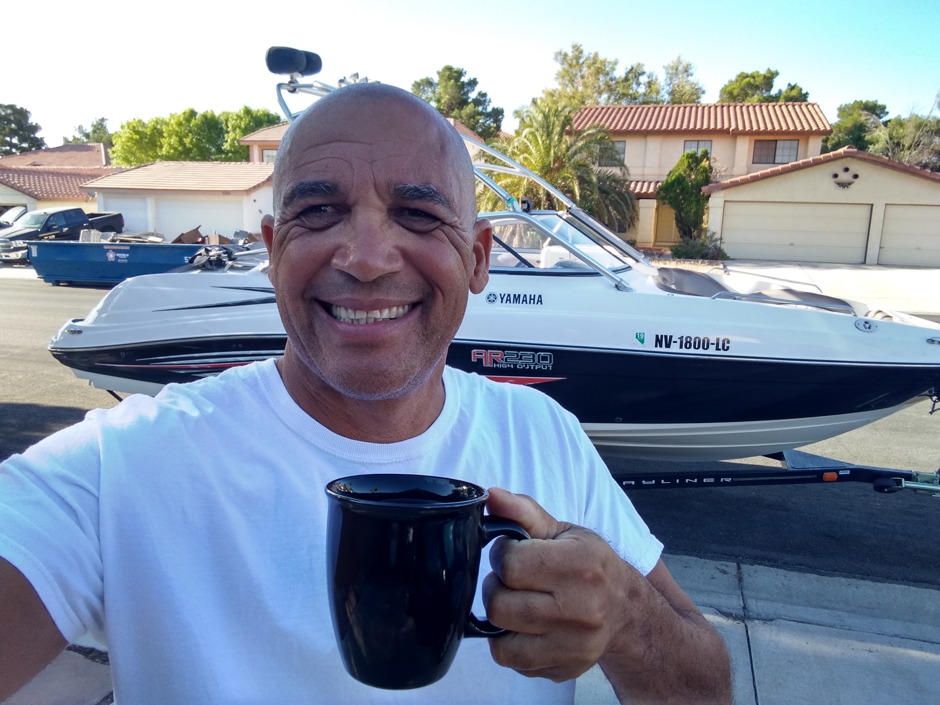 Steve drinking coffee by boat