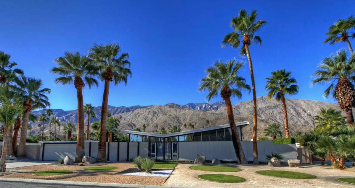Technician pressure washing a coastal home exterior in San Clemente