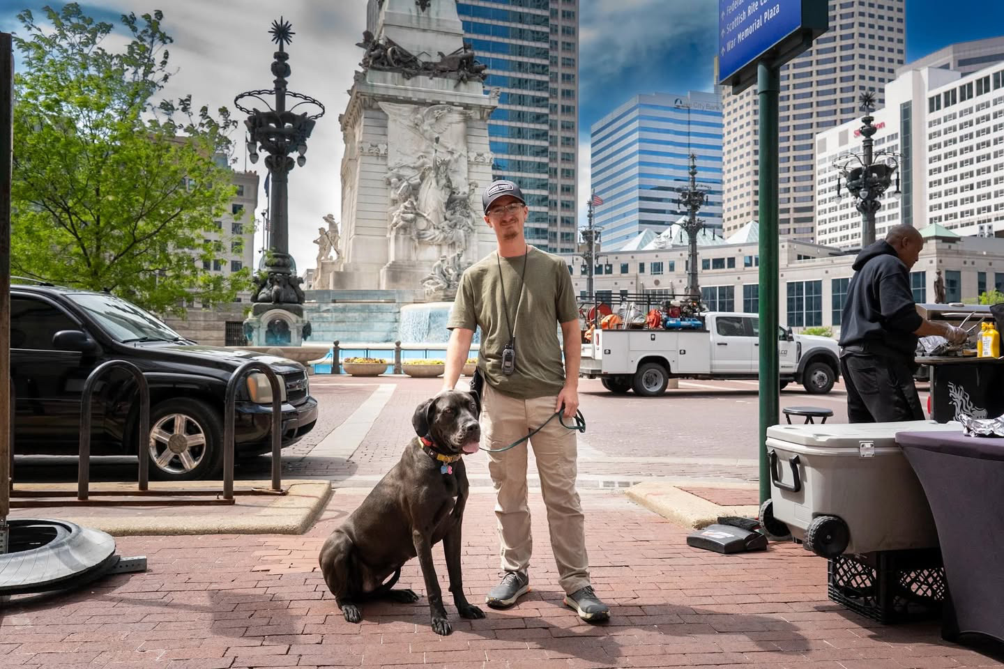 Man in green shirt with great dane at monument circle, Indianapolis