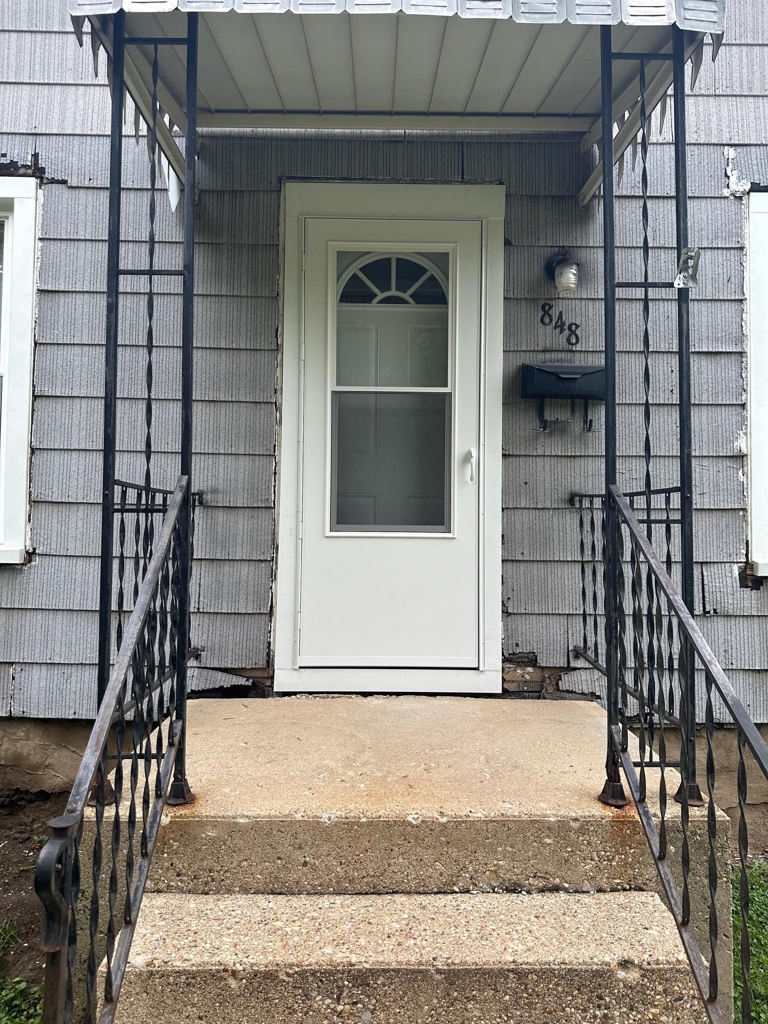 Precision Exteriors Inc. window installation service on a two-story home in Lena, IL.