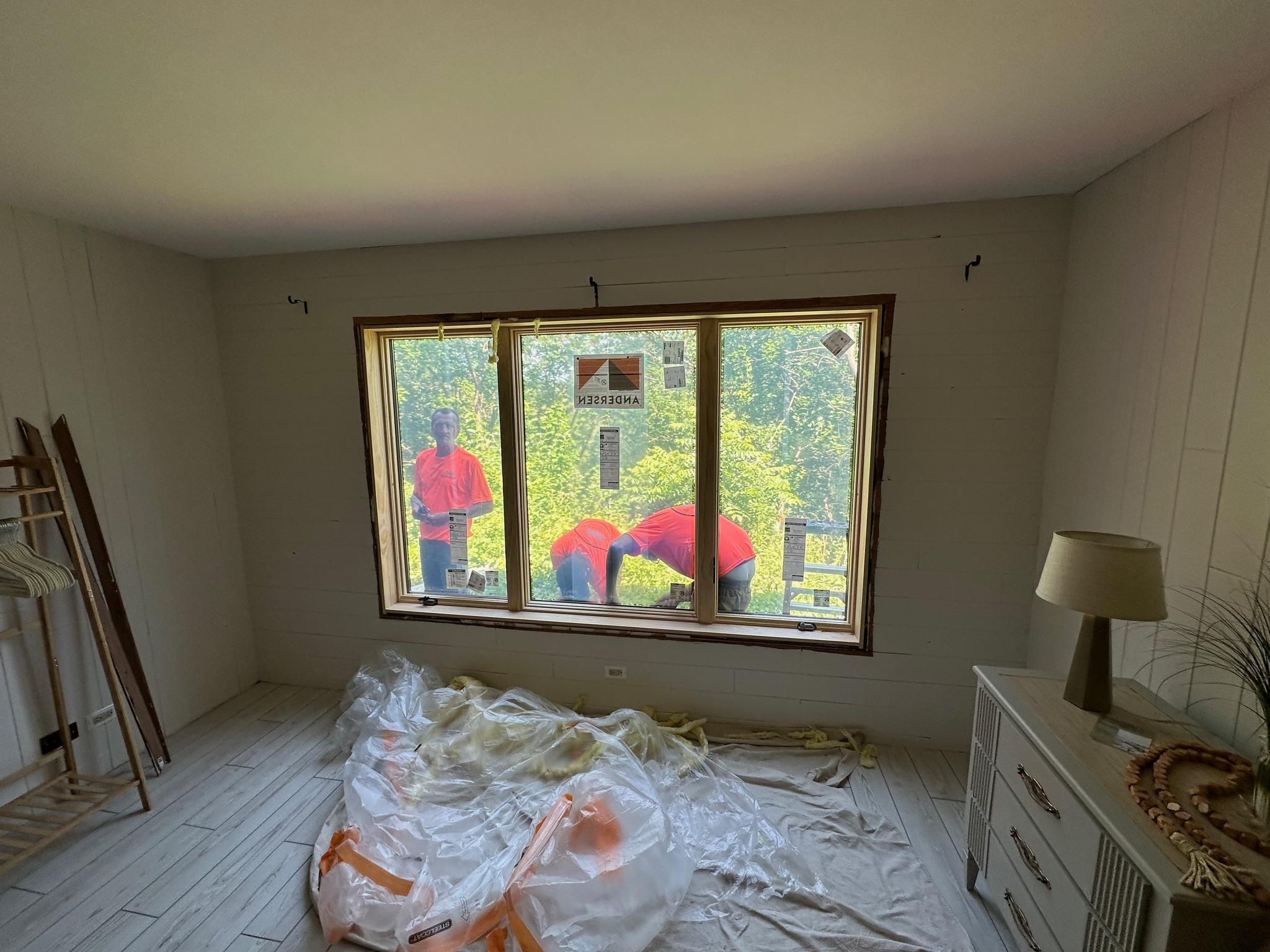 Living room view featuring newly replaced vinyl windows by Precision Exteriors Inc.