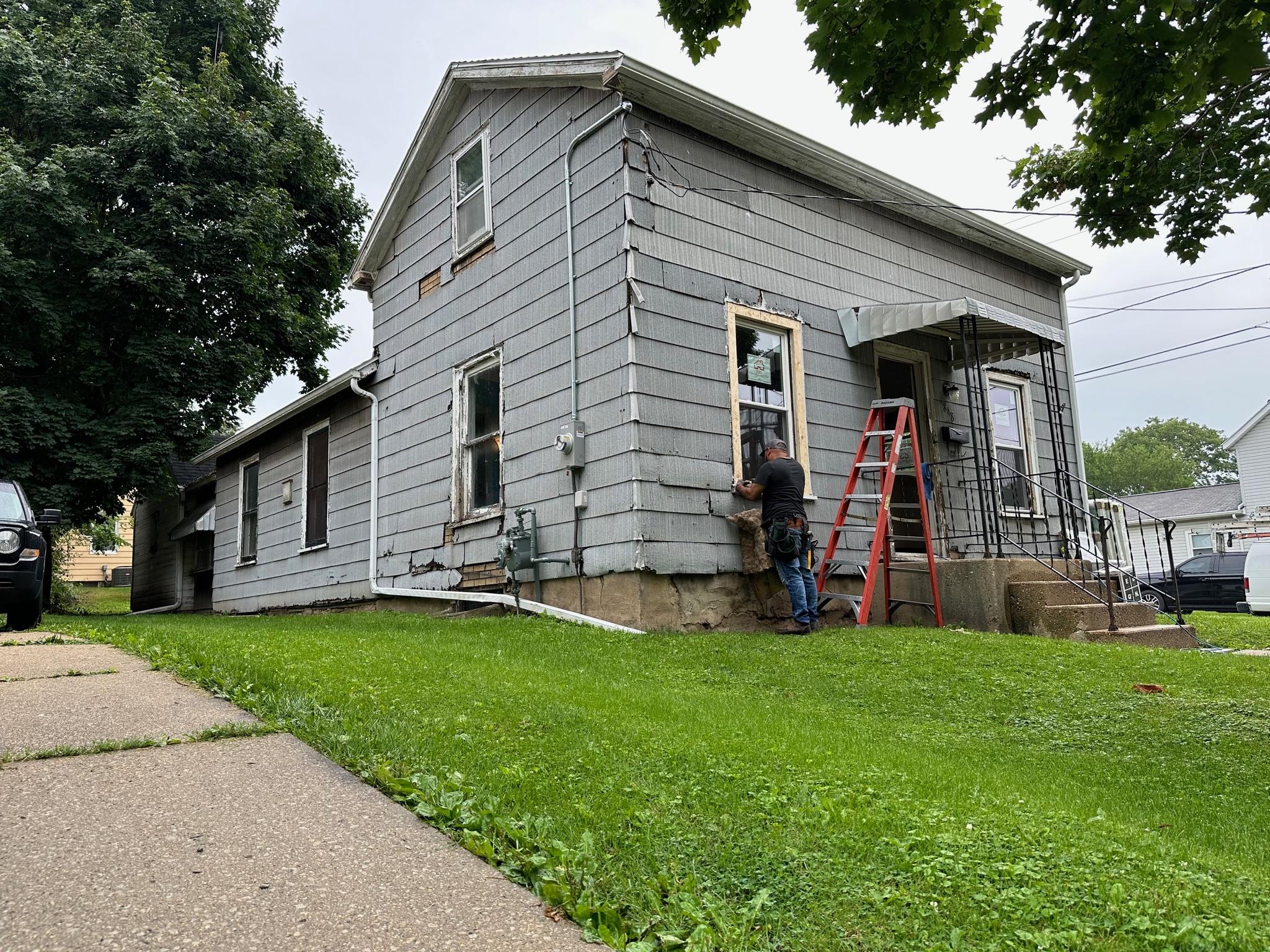 Completed residential window replacement on a suburban home by Precision Exteriors Inc. in Lena, IL.