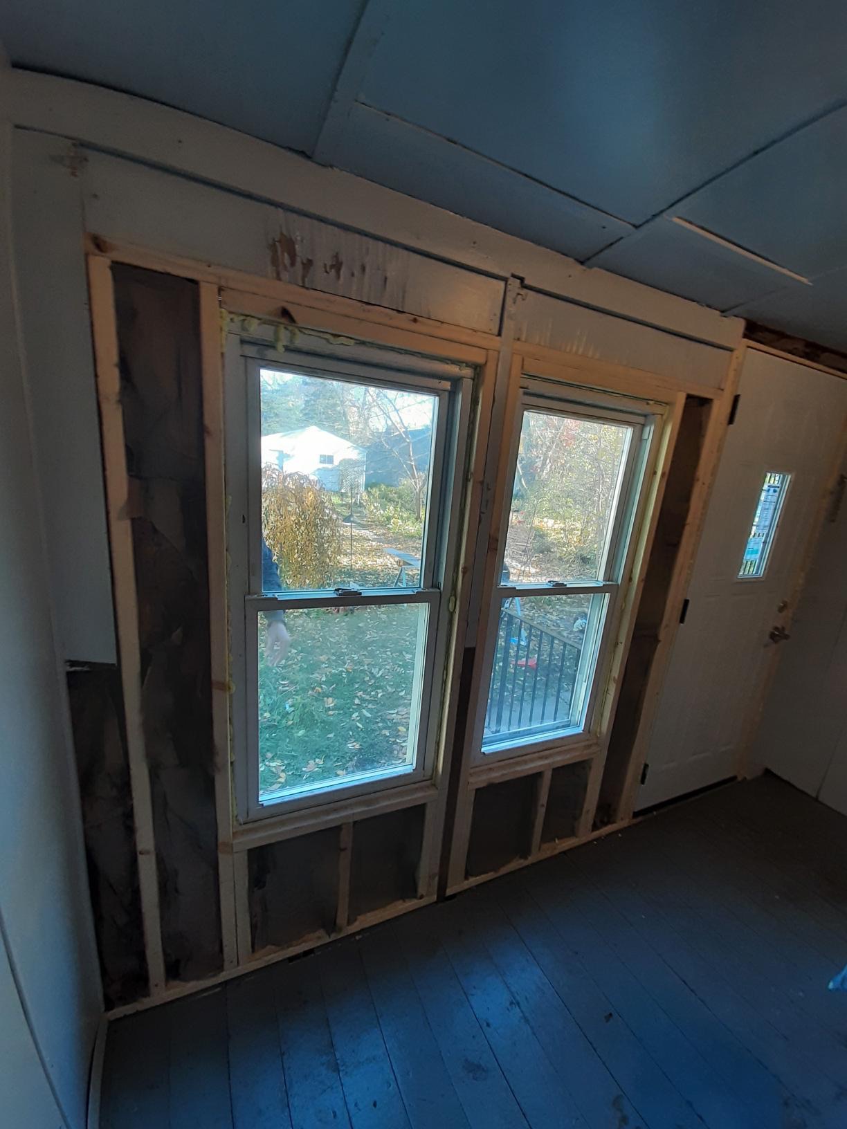 Modern replacement windows providing improved insulation for a suburban home.