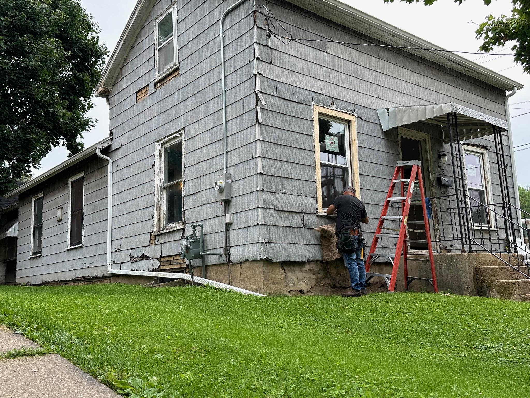 New vinyl replacement window with clean white trim on a home.