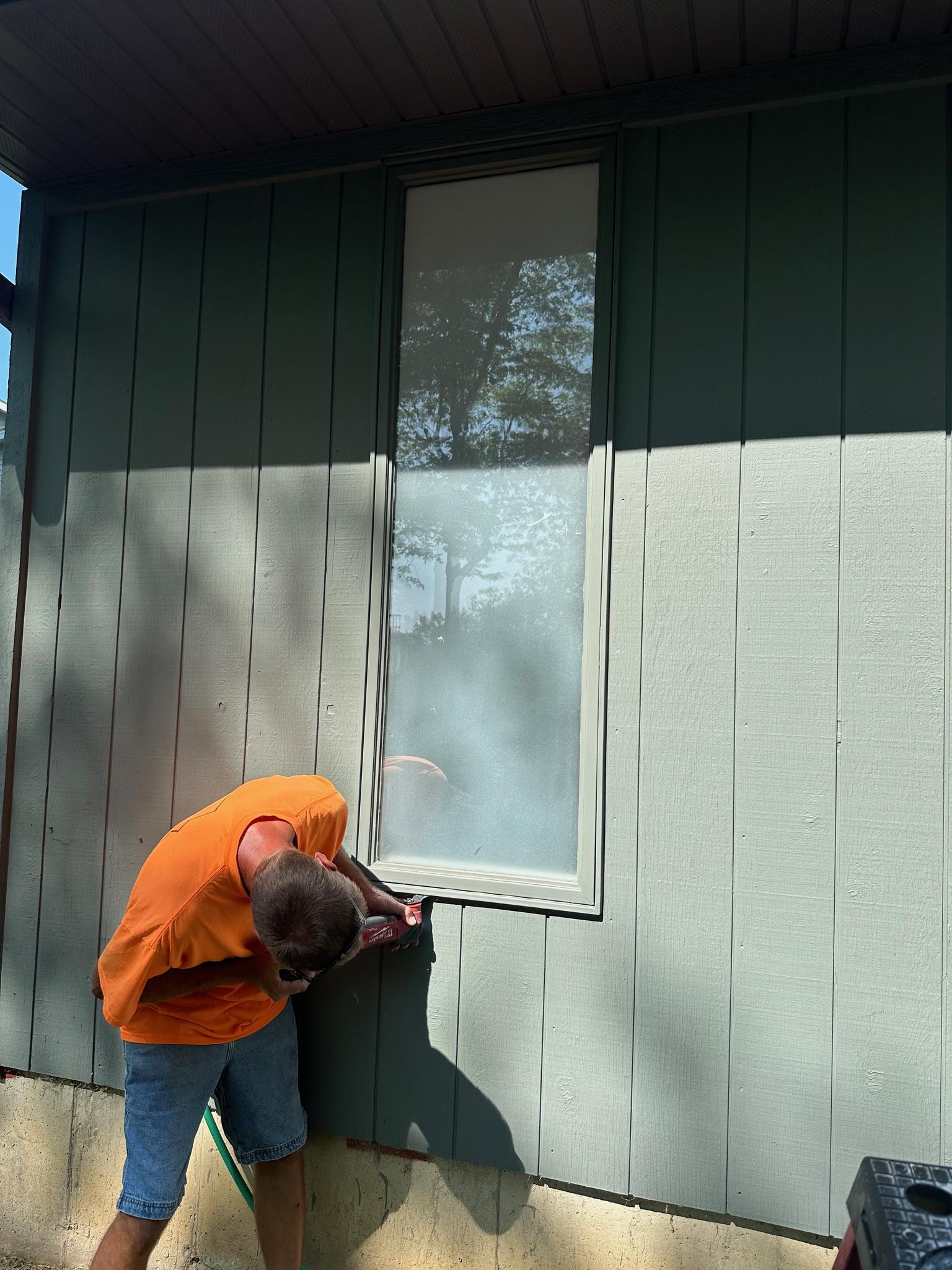 Freshly updated vinyl replacement windows on a light-colored home.