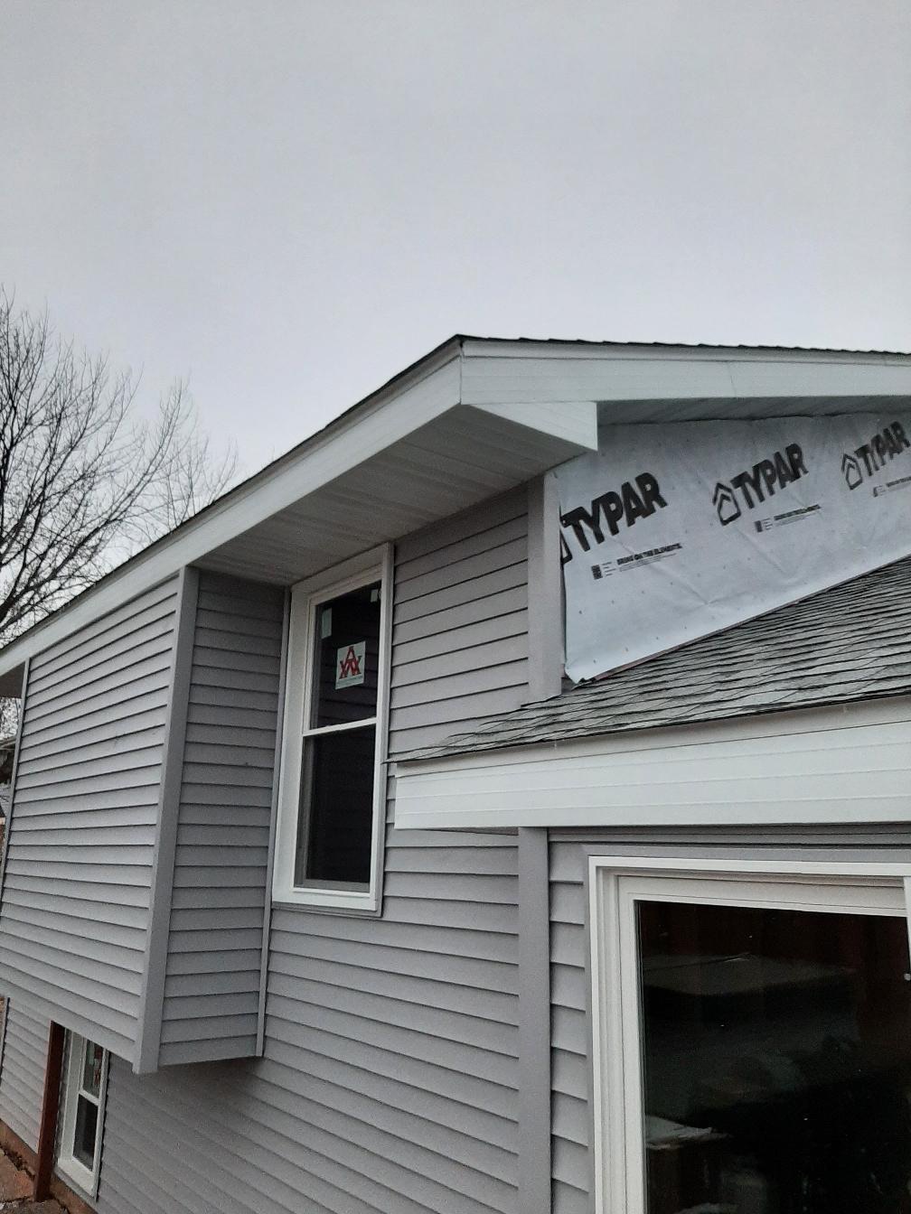 Home exterior remodel showing protective house wrap before the final siding.