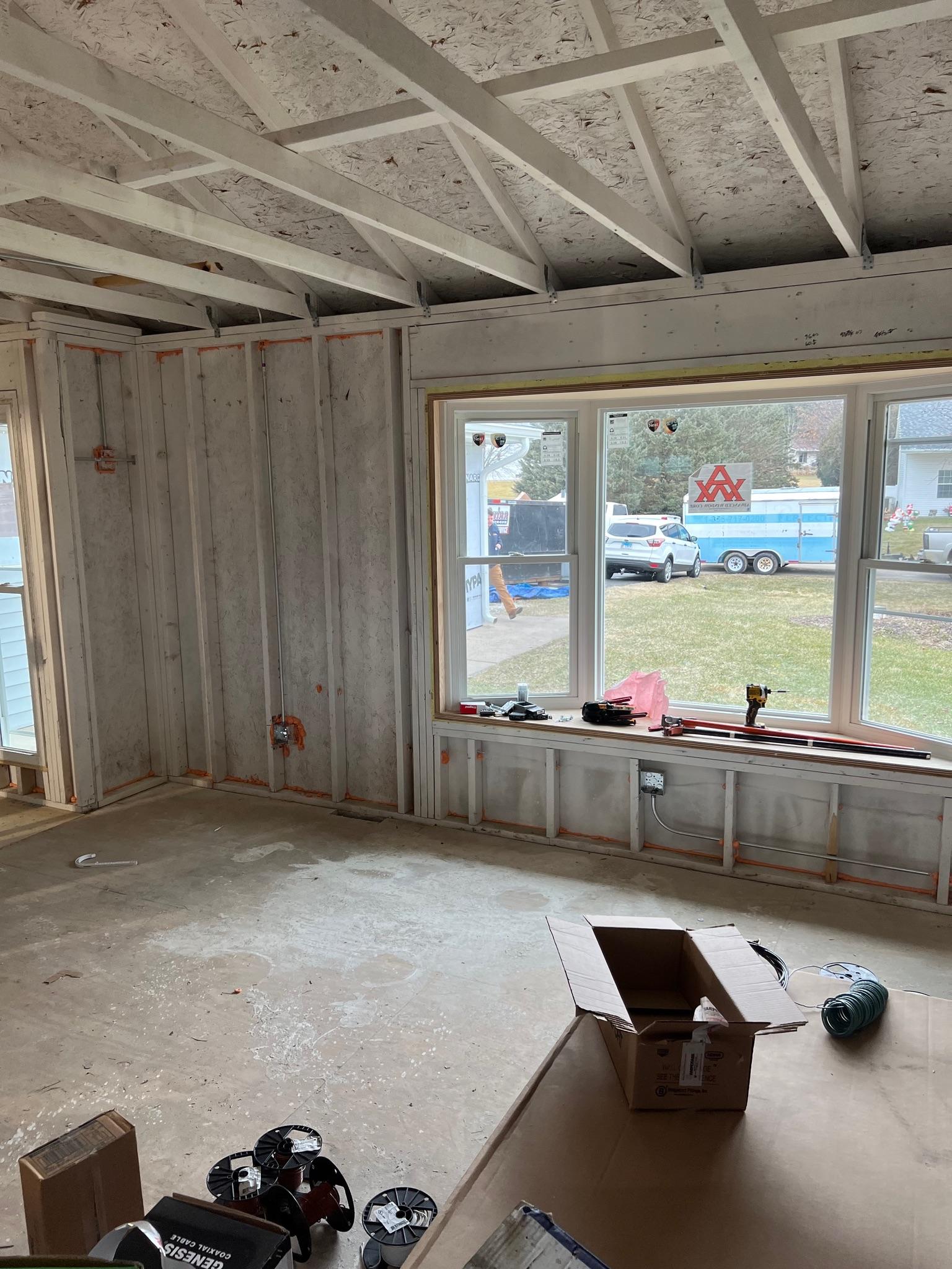 Completed window installation project on a two-story residential house.