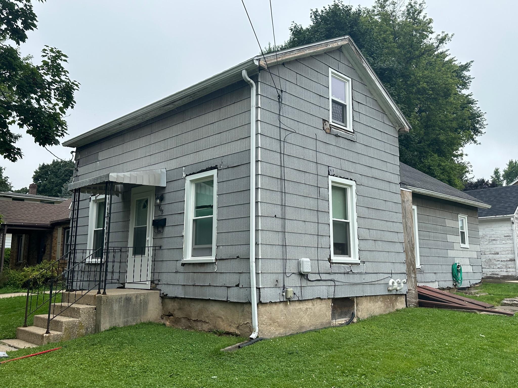 New double-hung window replacement near Lena, IL, enhancing home curb appeal.