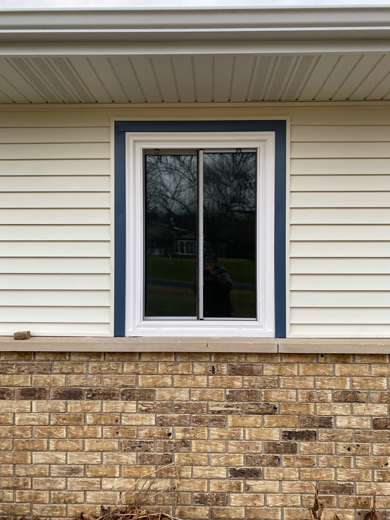 Newly installed bedroom windows with pristine white vinyl frames.