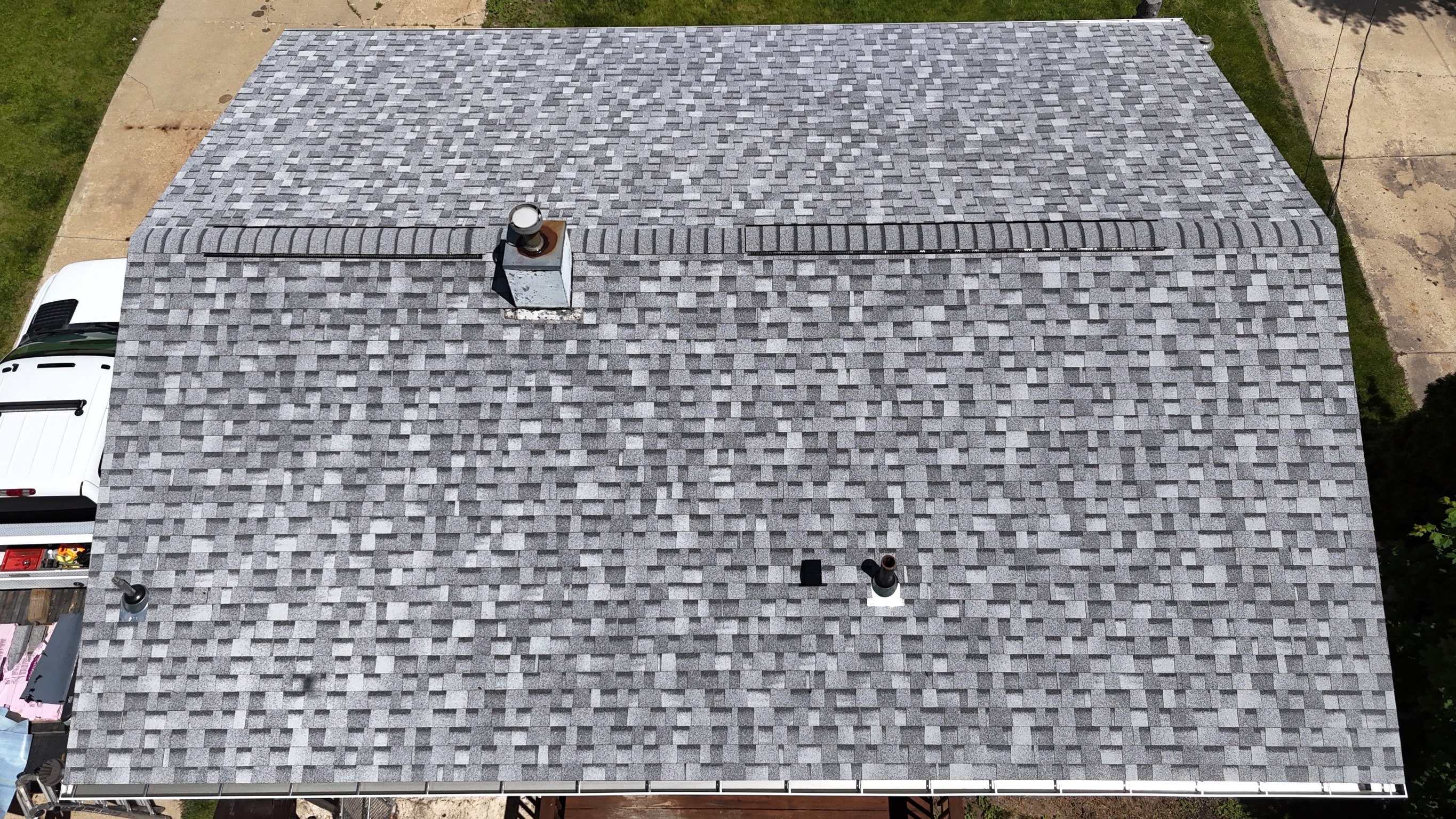 Close-up texture view of a freshly completed asphalt shingle roof.