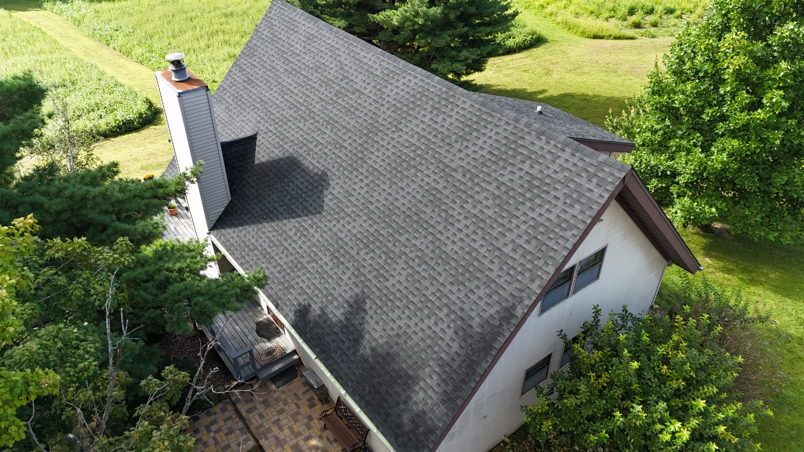Aerial view of a home with a professionally installed new roof by Precision Exteriors Inc.