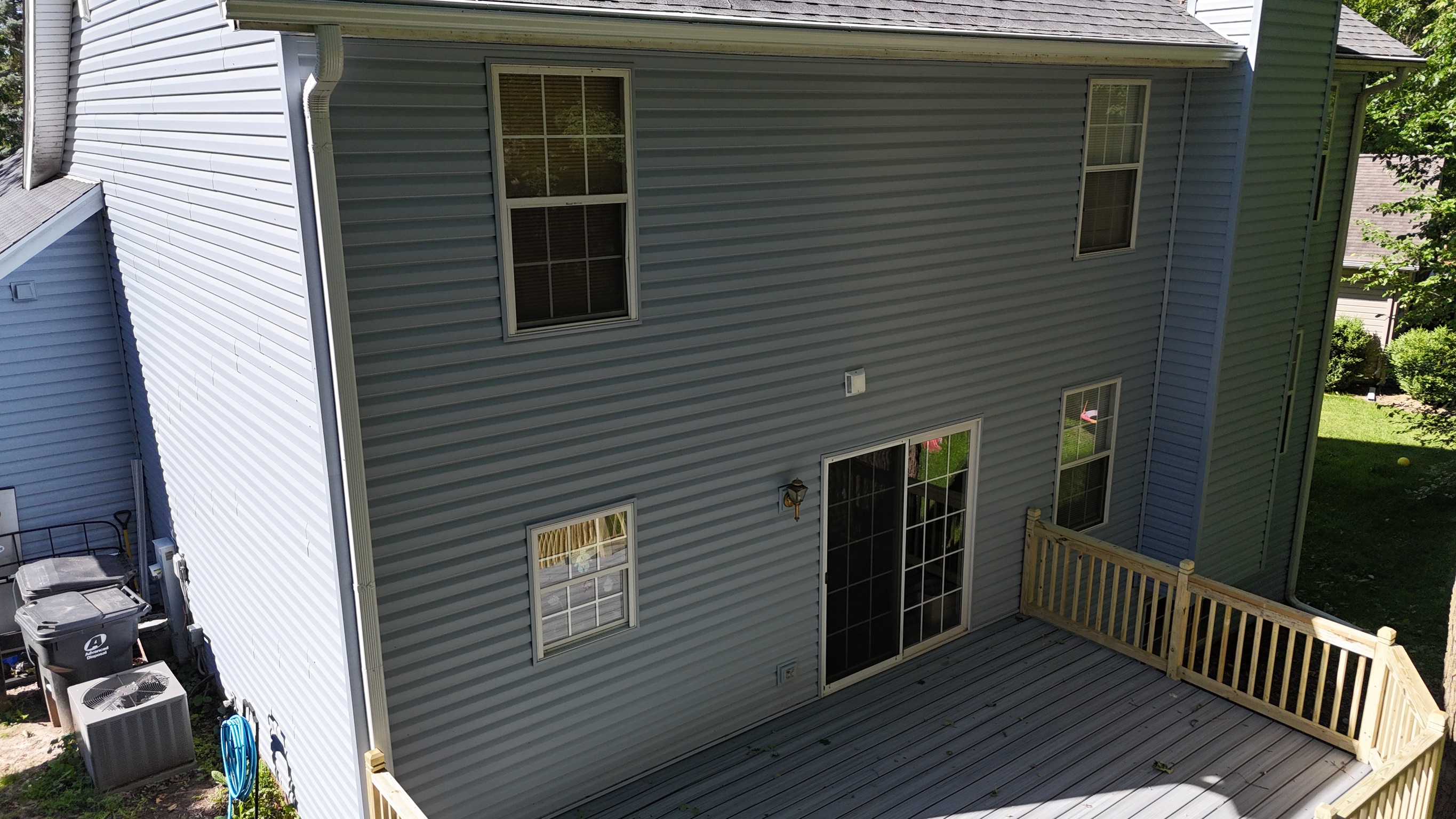 Drone view of a finished home roof replacement showing clean shingle lines.