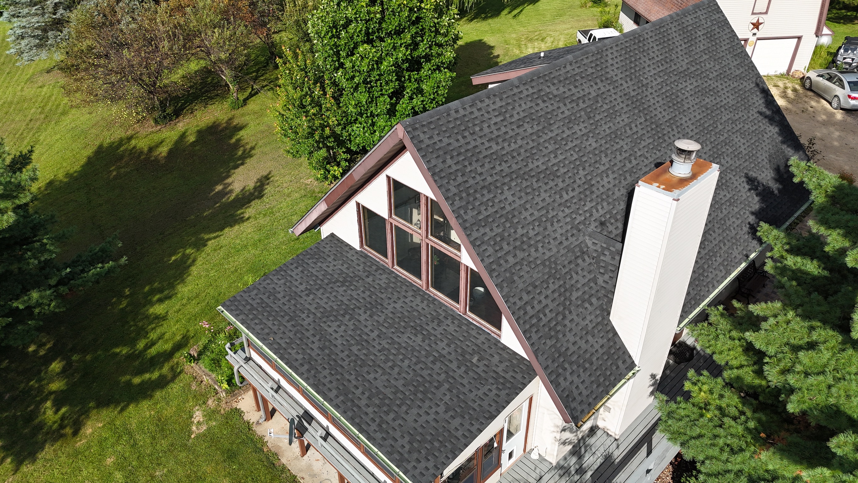Aerial view of a completed asphalt shingle roof replacement project.
