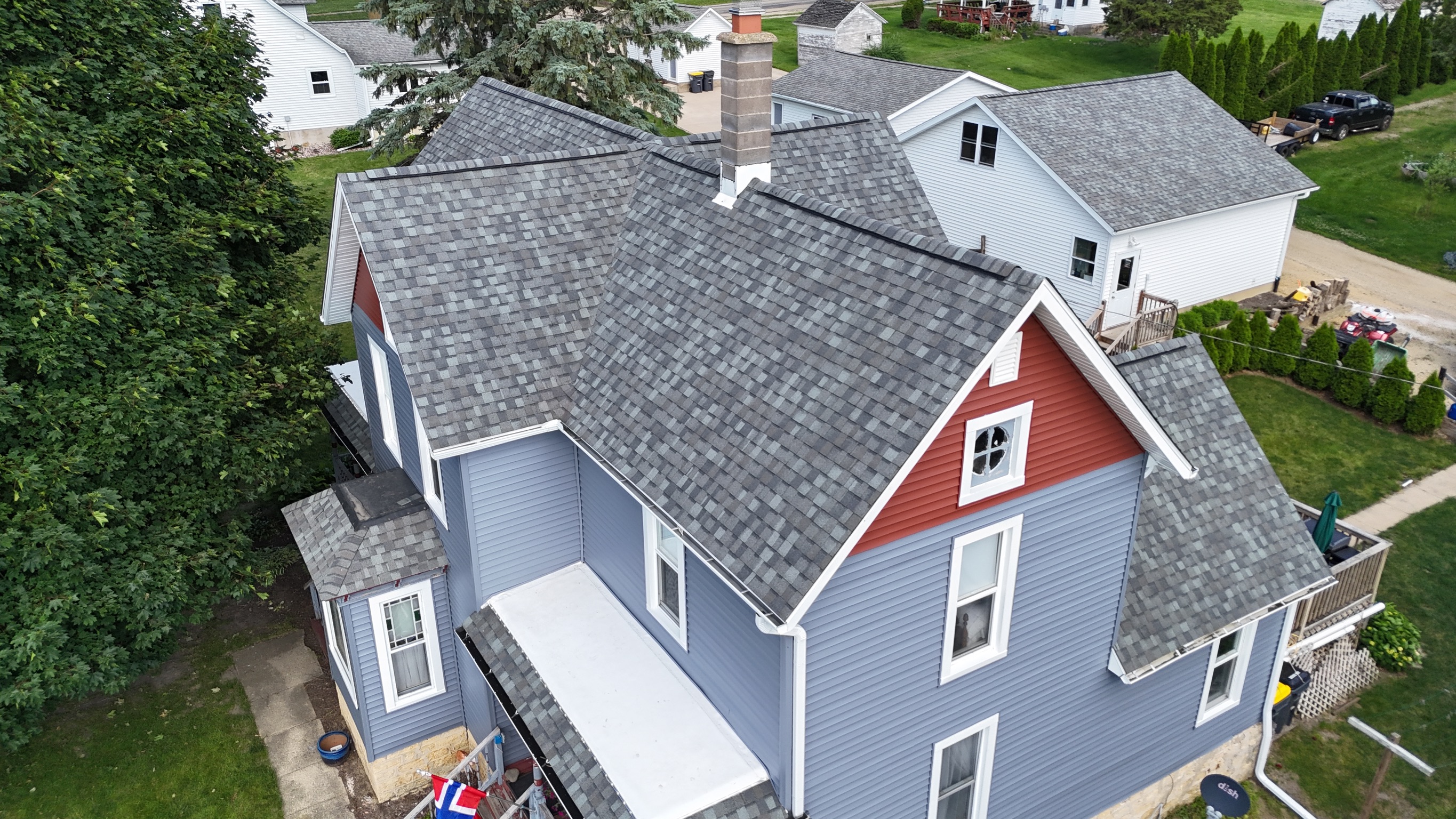 Drone view of a finished home roof replacement by Precision Exteriors Inc.