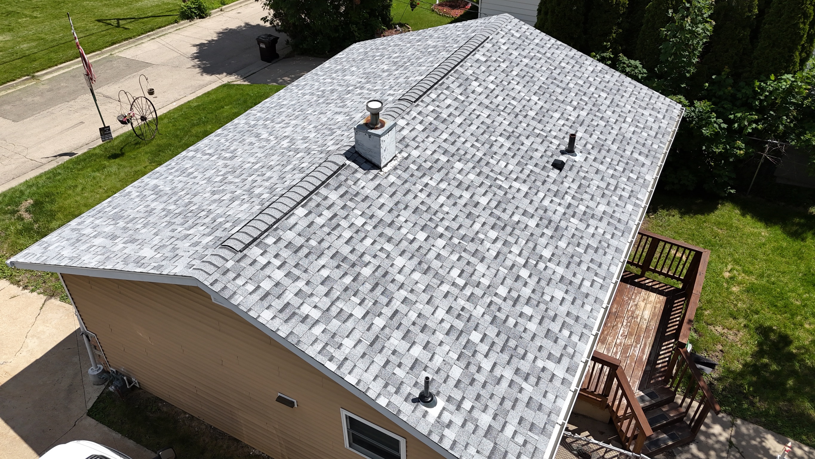 Completed roof replacement project with dark gray architectural shingles.