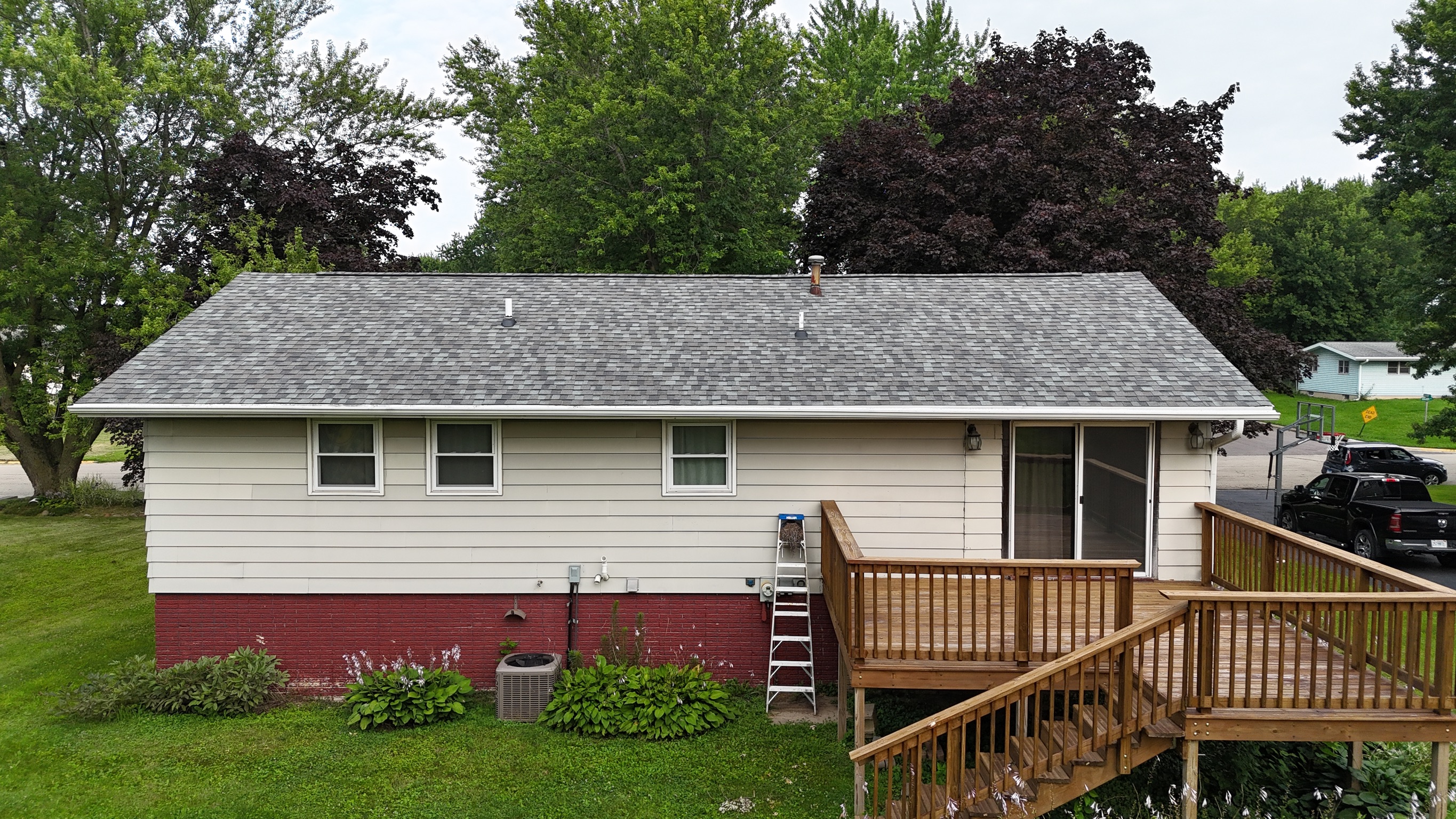 Finished residential roof showing properly aligned gray shingles.