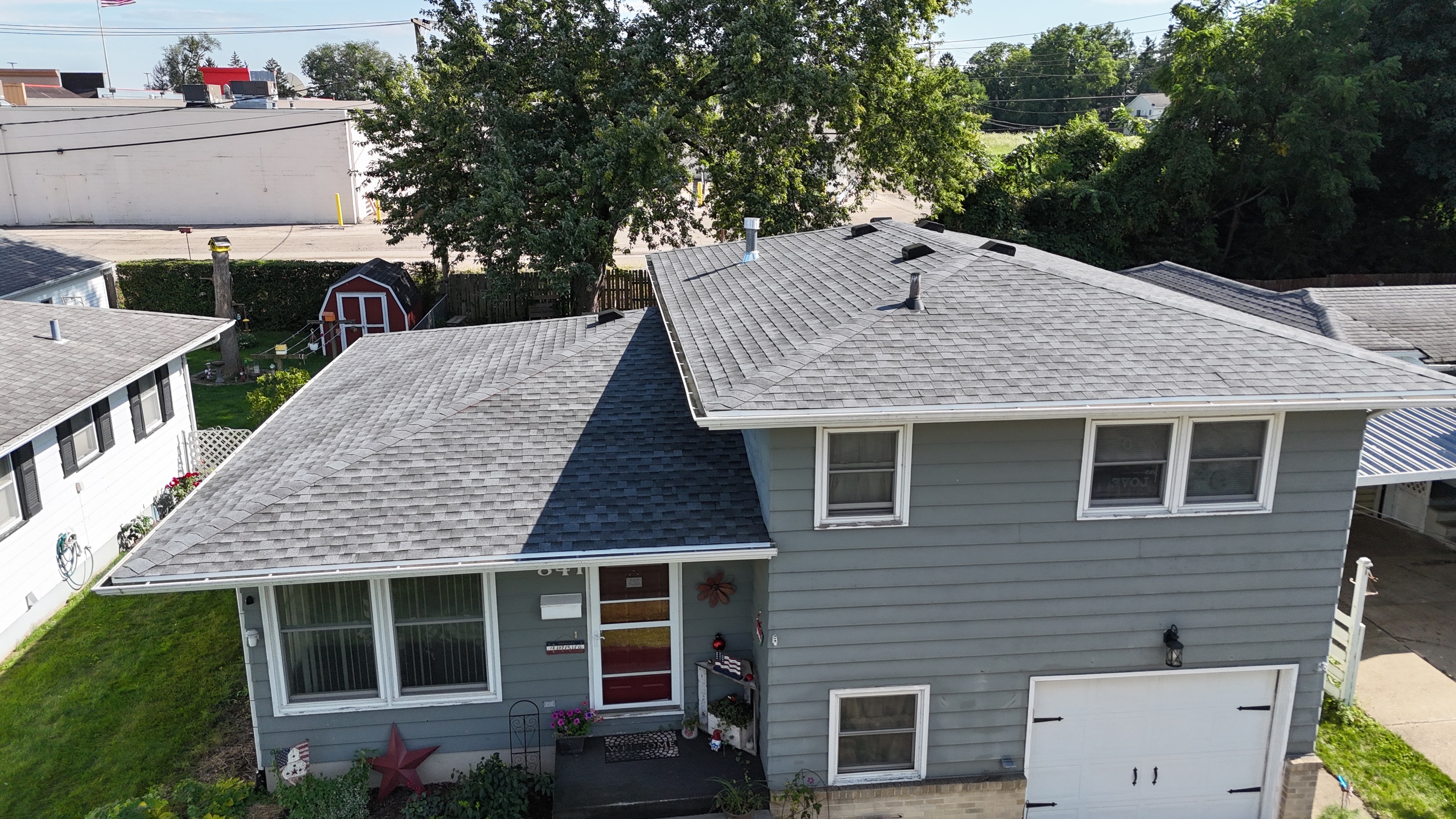 Aerial view of a clean, newly installed shingle roof.