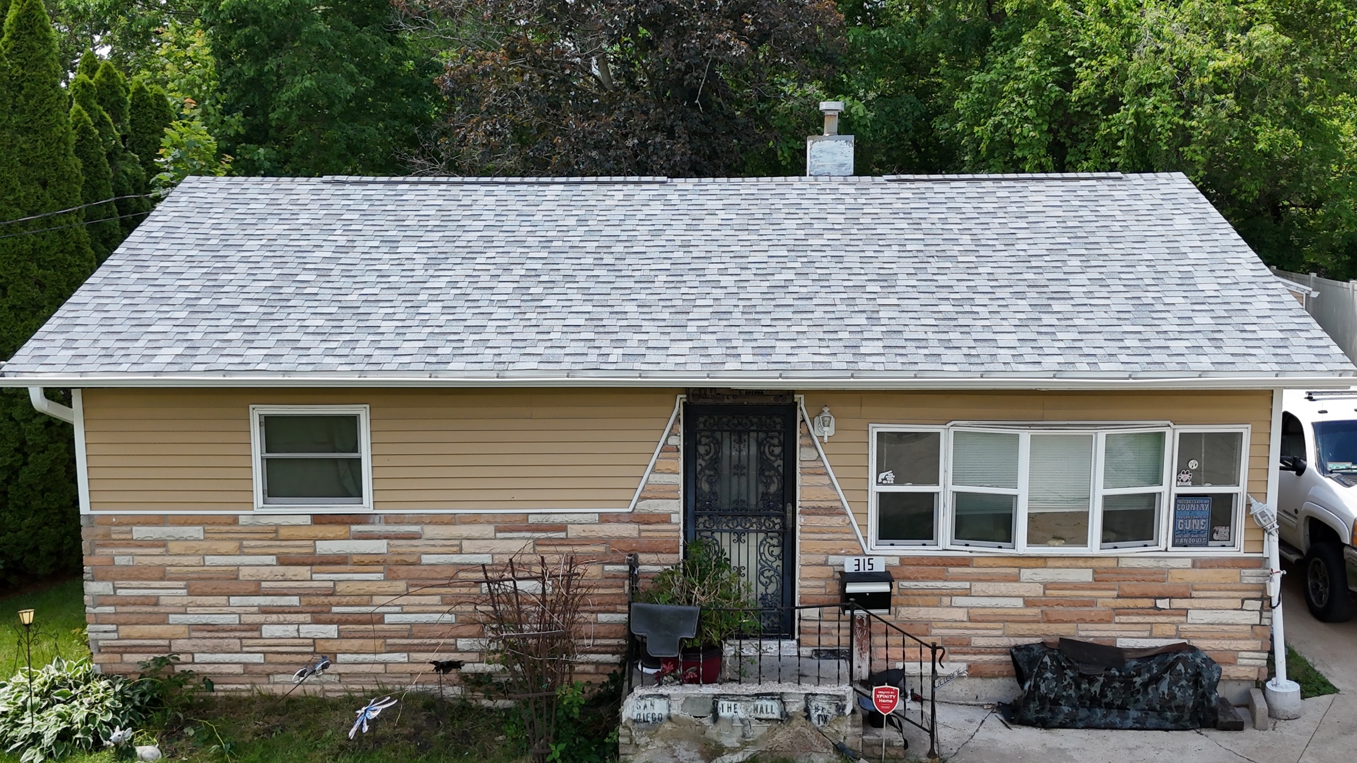 Aerial view of a finished gray architectural shingle roof by Precision Exteriors Inc.