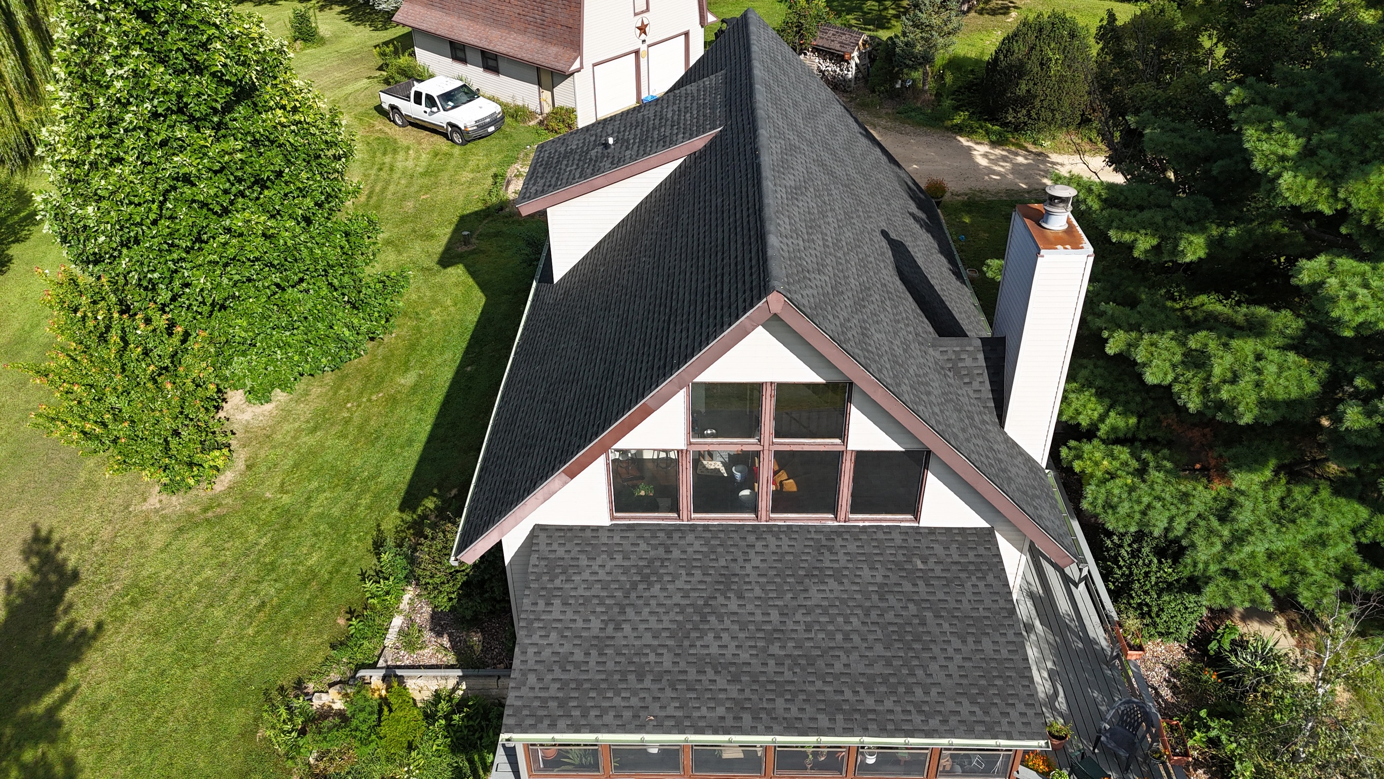 New charcoal gray shingle roof on a multi-gabled residential home.