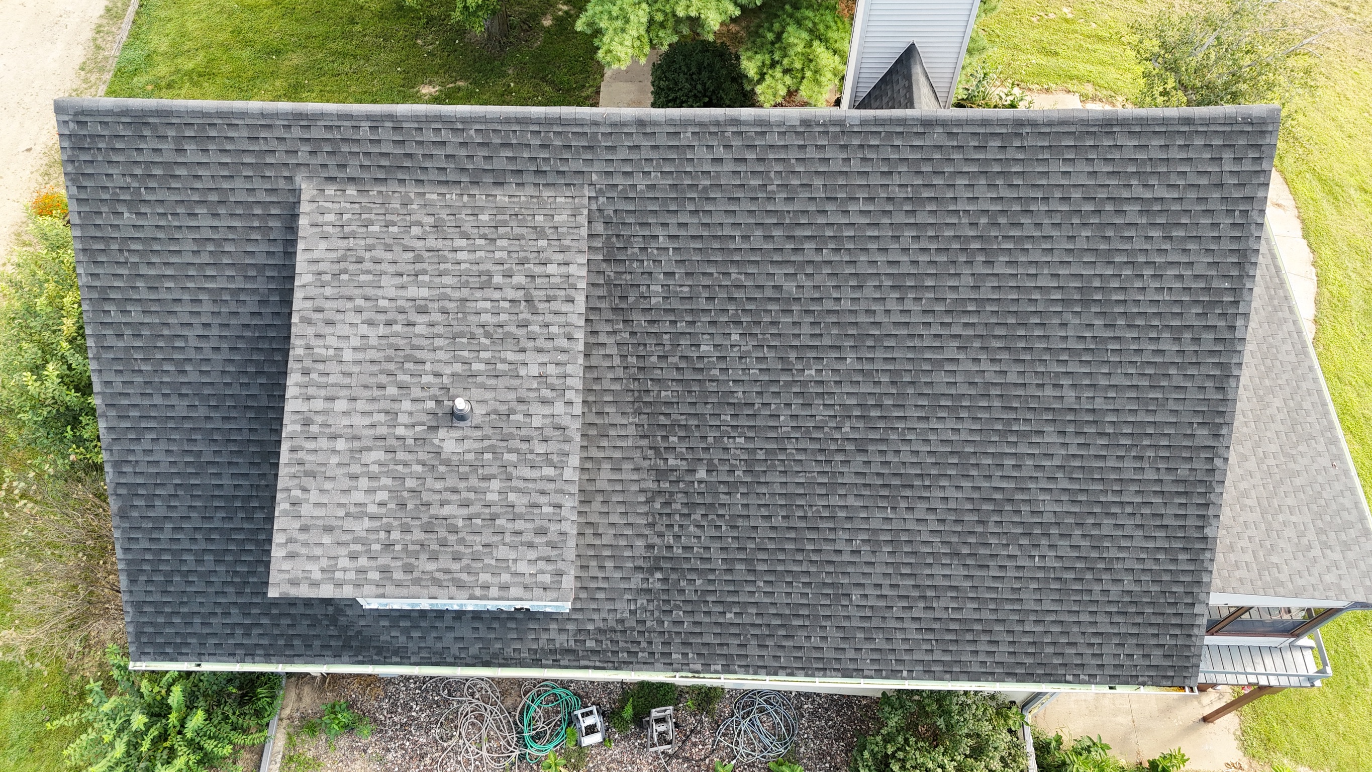 Aerial perspective of high-quality architectural shingles installed on a home.