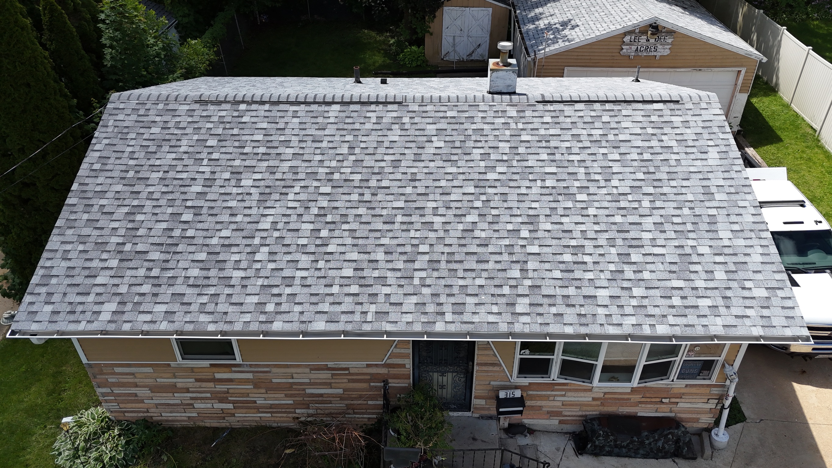 Finished asphalt shingle roof replacement by professional contractors.