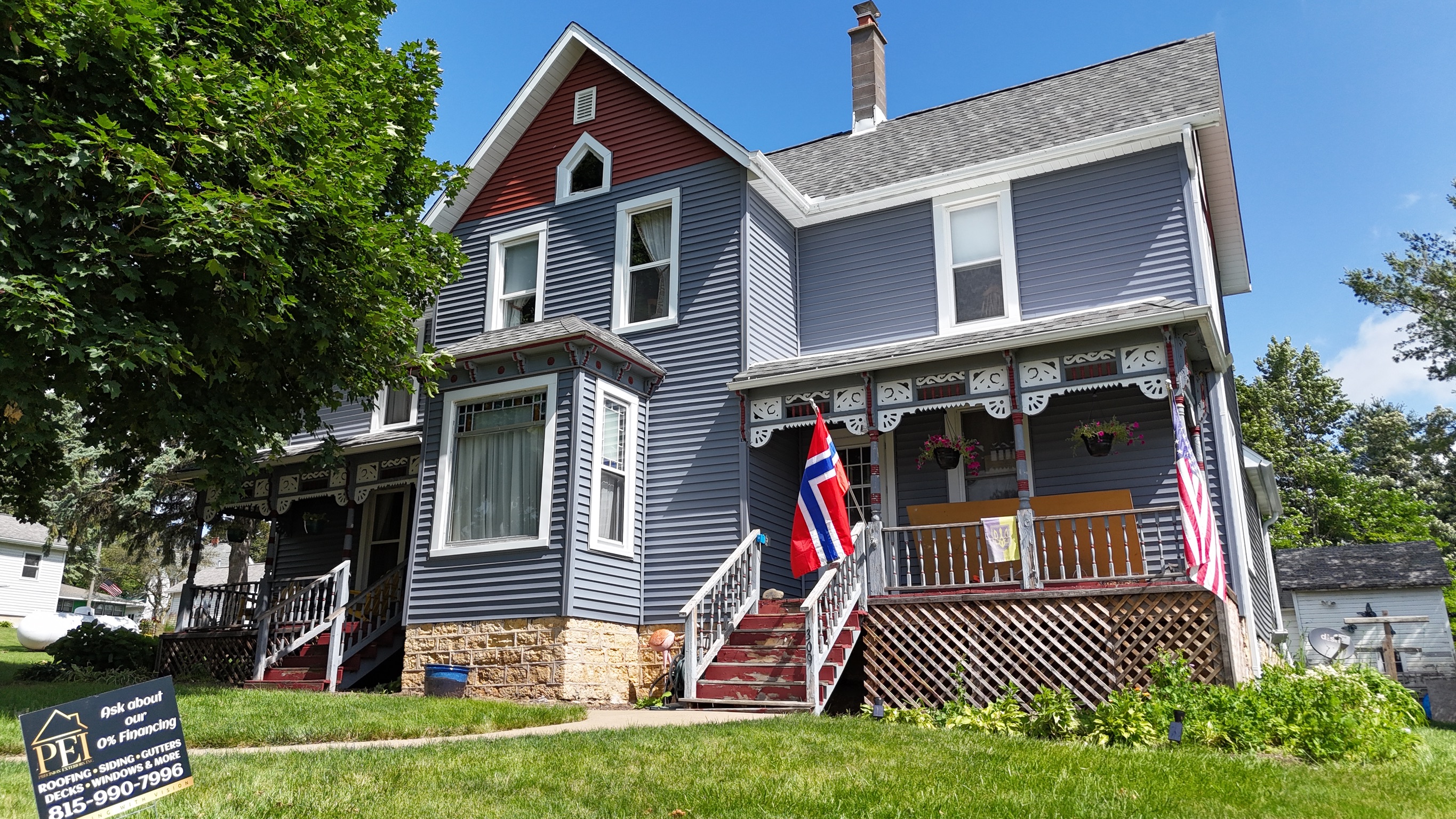 Front view of a beautiful home featuring a newly replaced shingle roof.