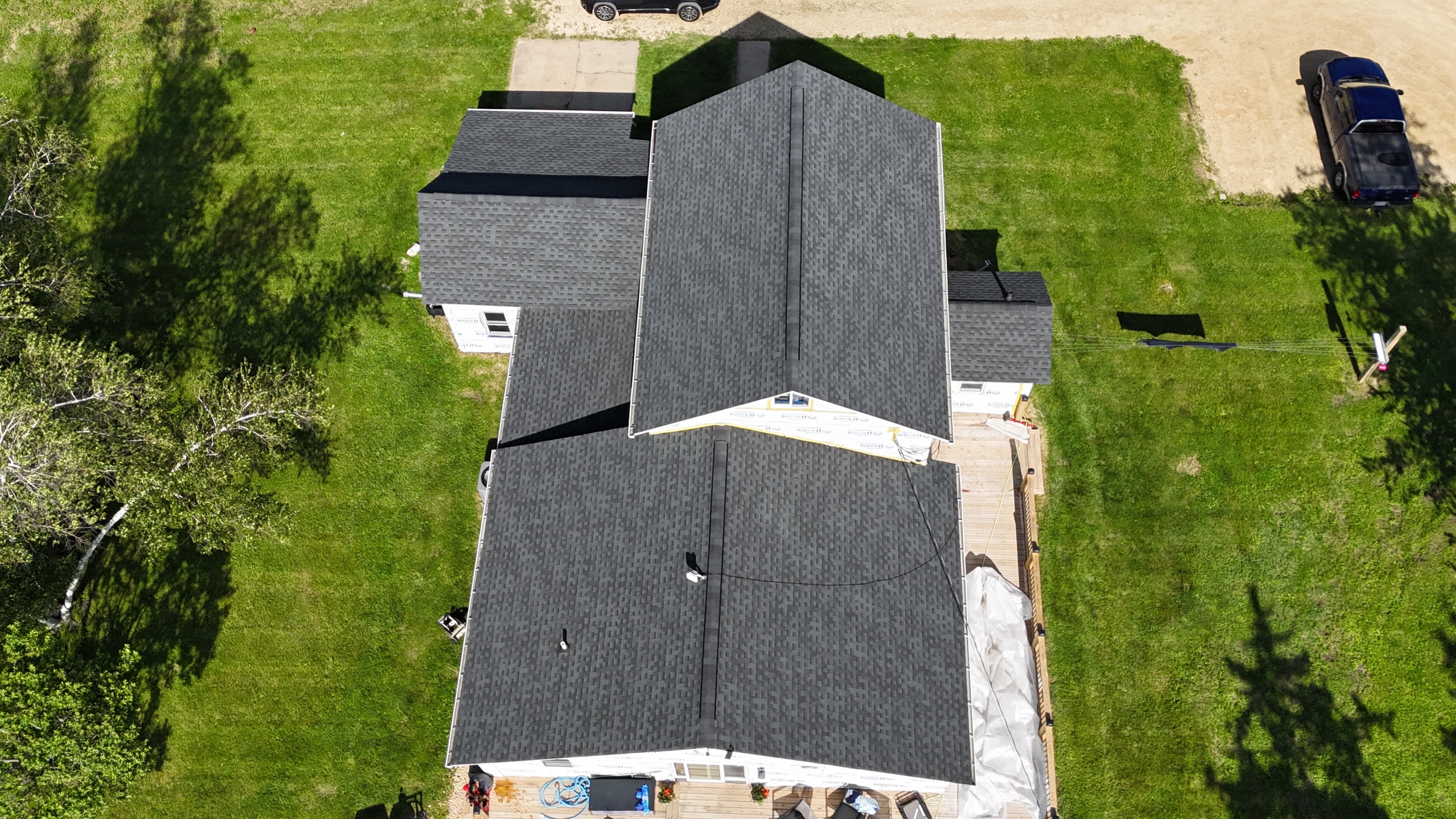 Drone perspective of a finished residential roof replacement project.