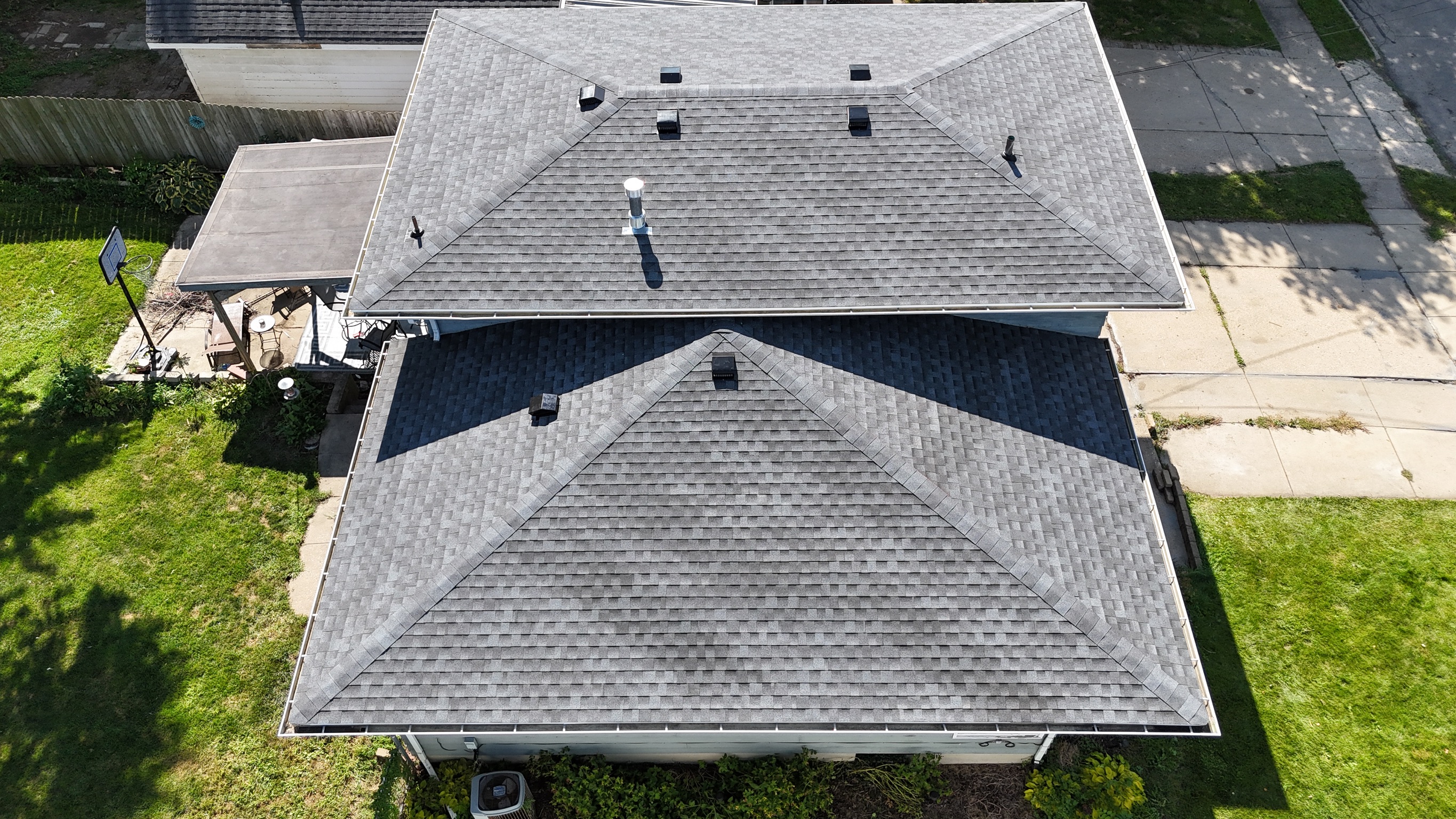 Aerial view of a completed roof replacement project near Lena, IL by Precision Exteriors Inc.