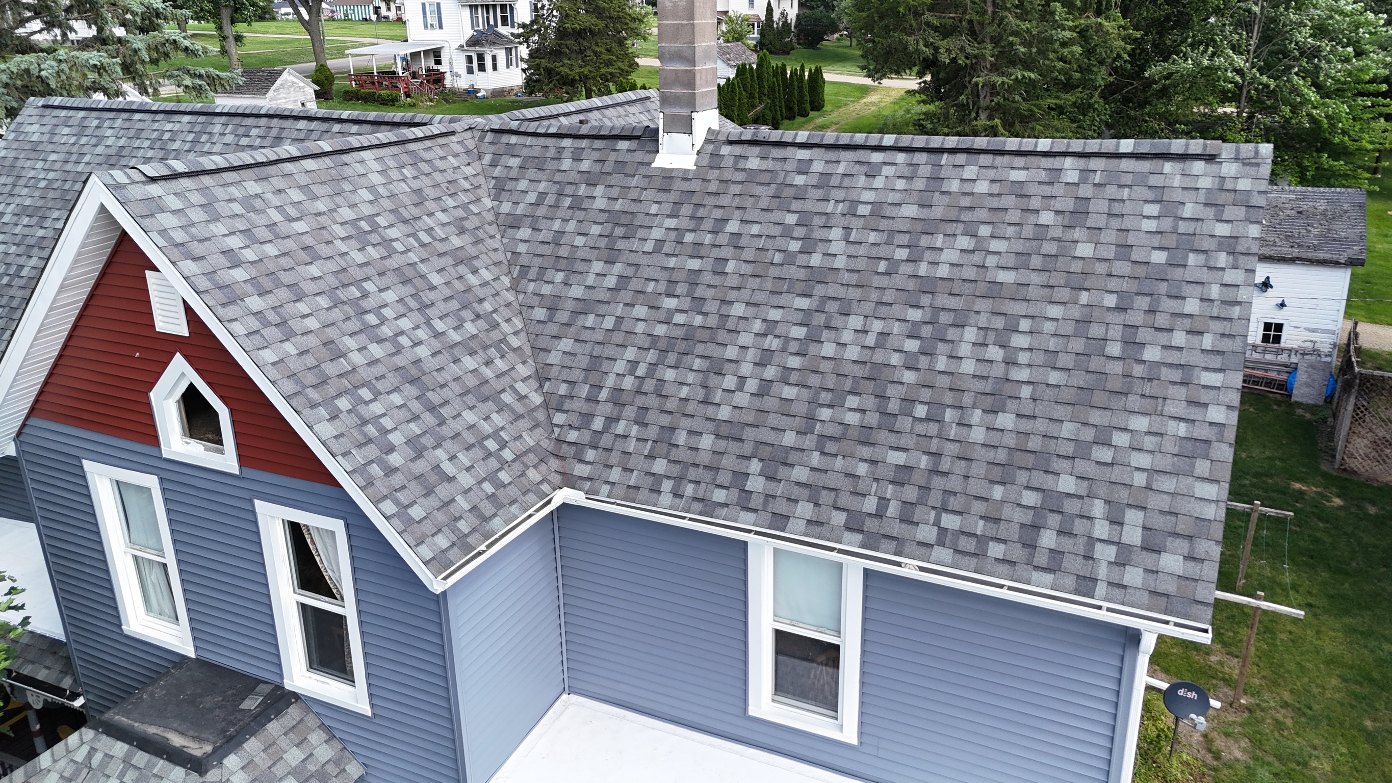 Completed roofing project with gray architectural shingles.