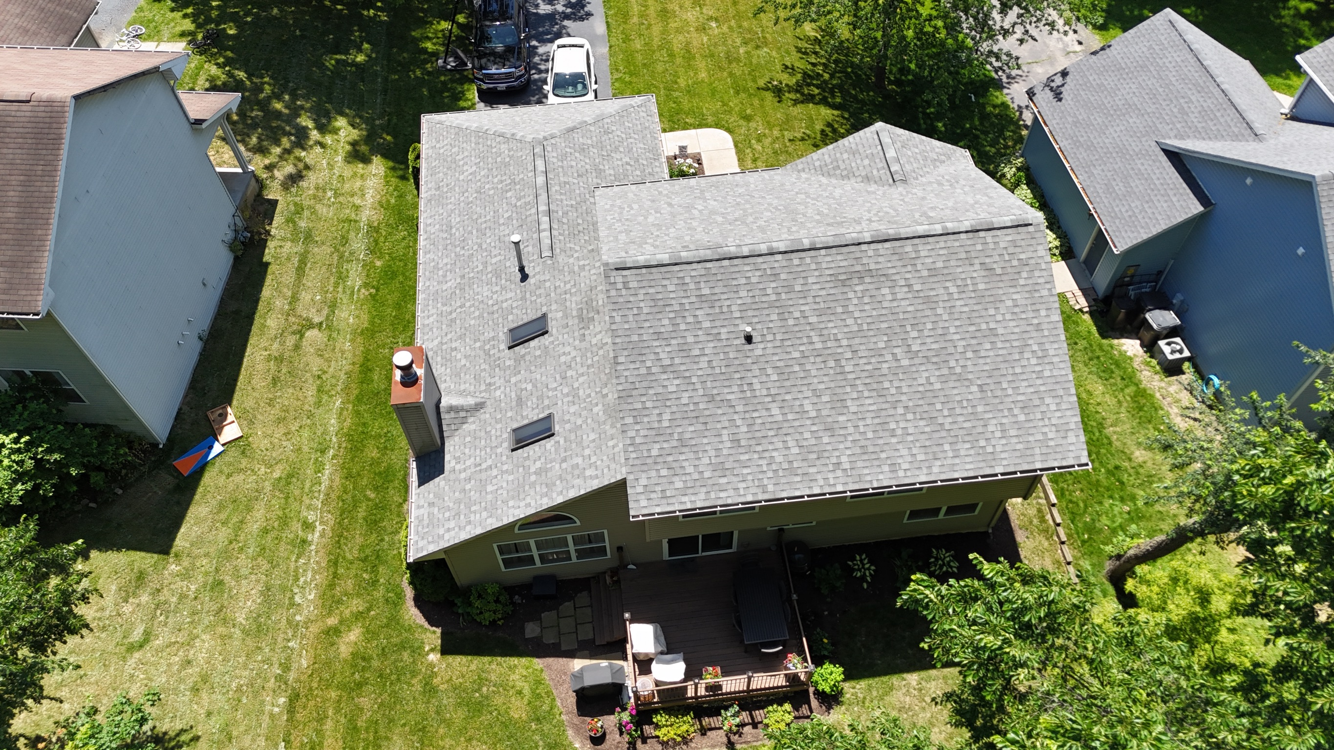Finished residential roof with brand new asphalt shingles.