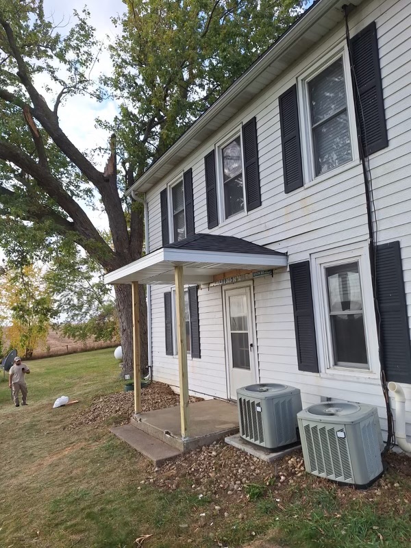 Front view of a two-story home with fresh white siding.
