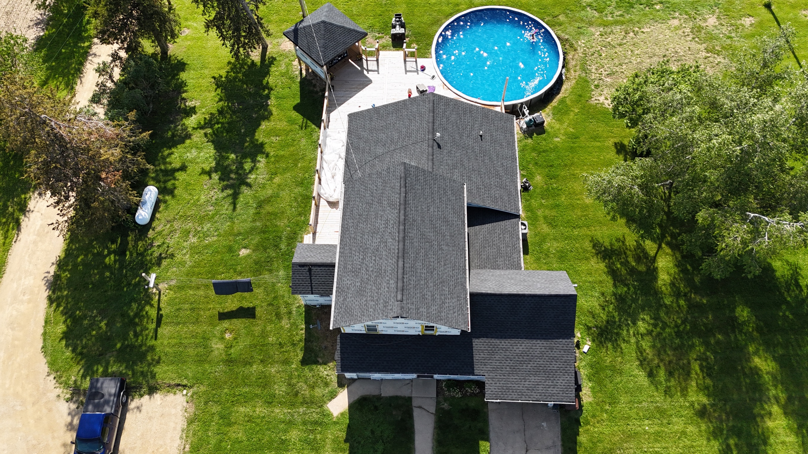 Finished dark gray asphalt shingle roof on a two-story home.