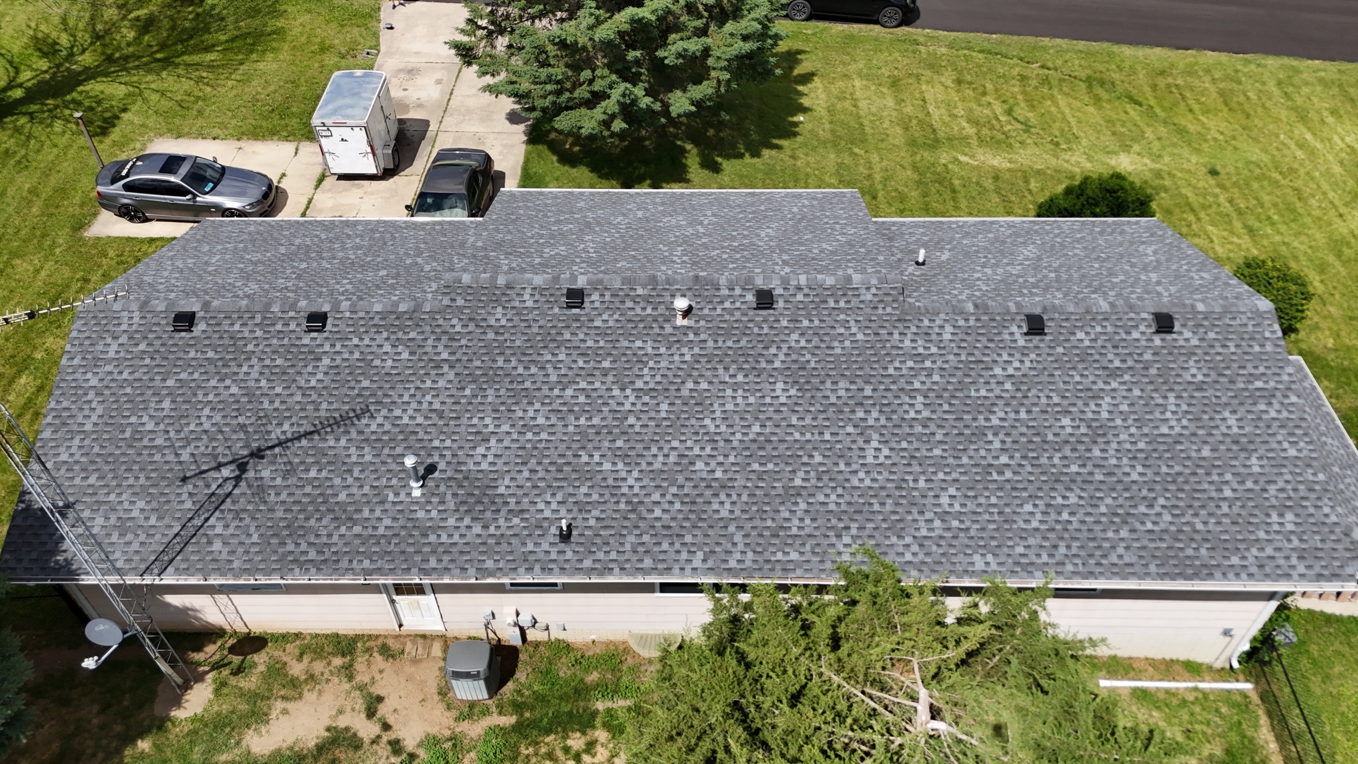 Close-up view of a finished garage roof with new shingles.