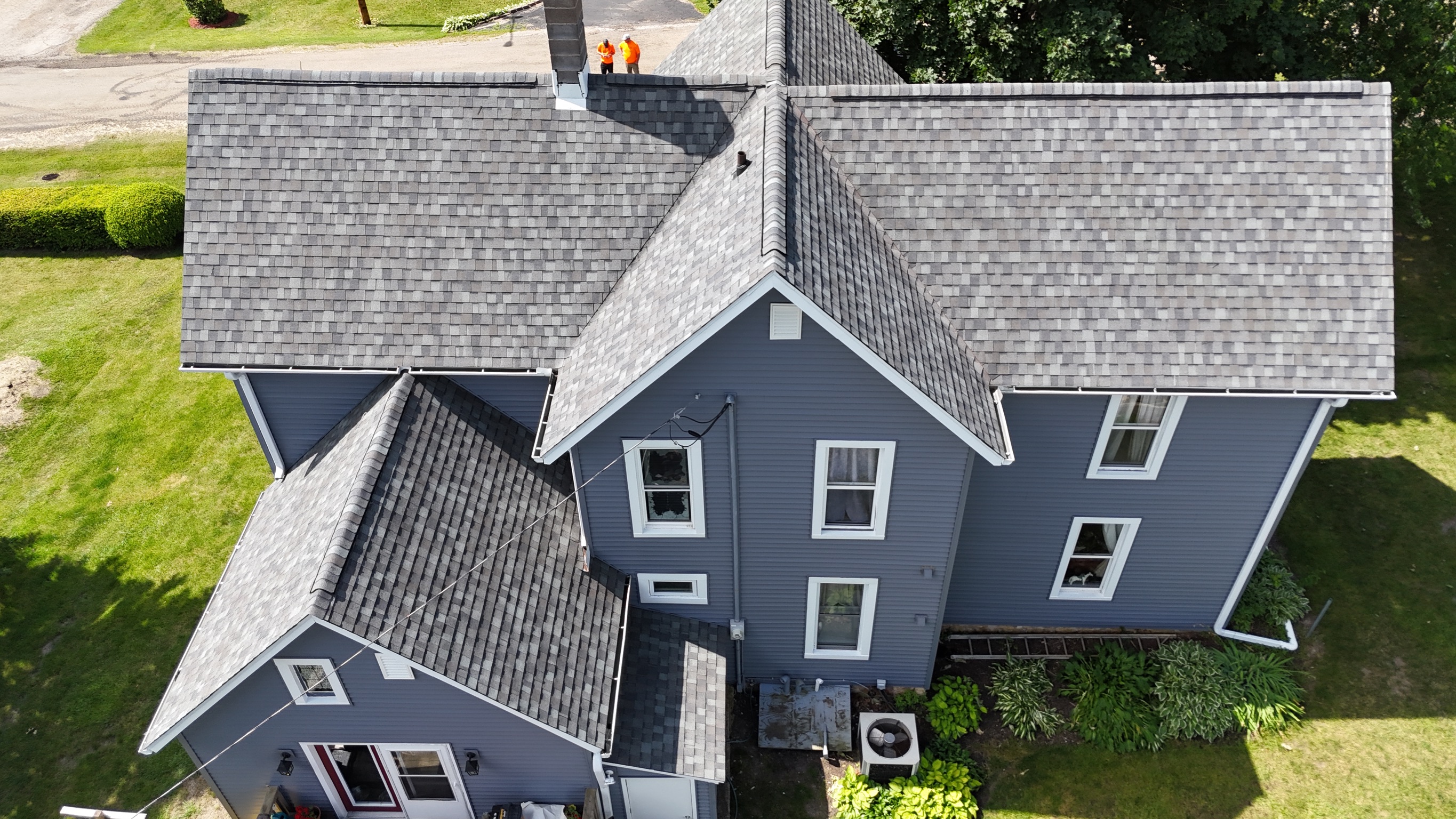 Completed residential roof replacement project on a suburban home.
