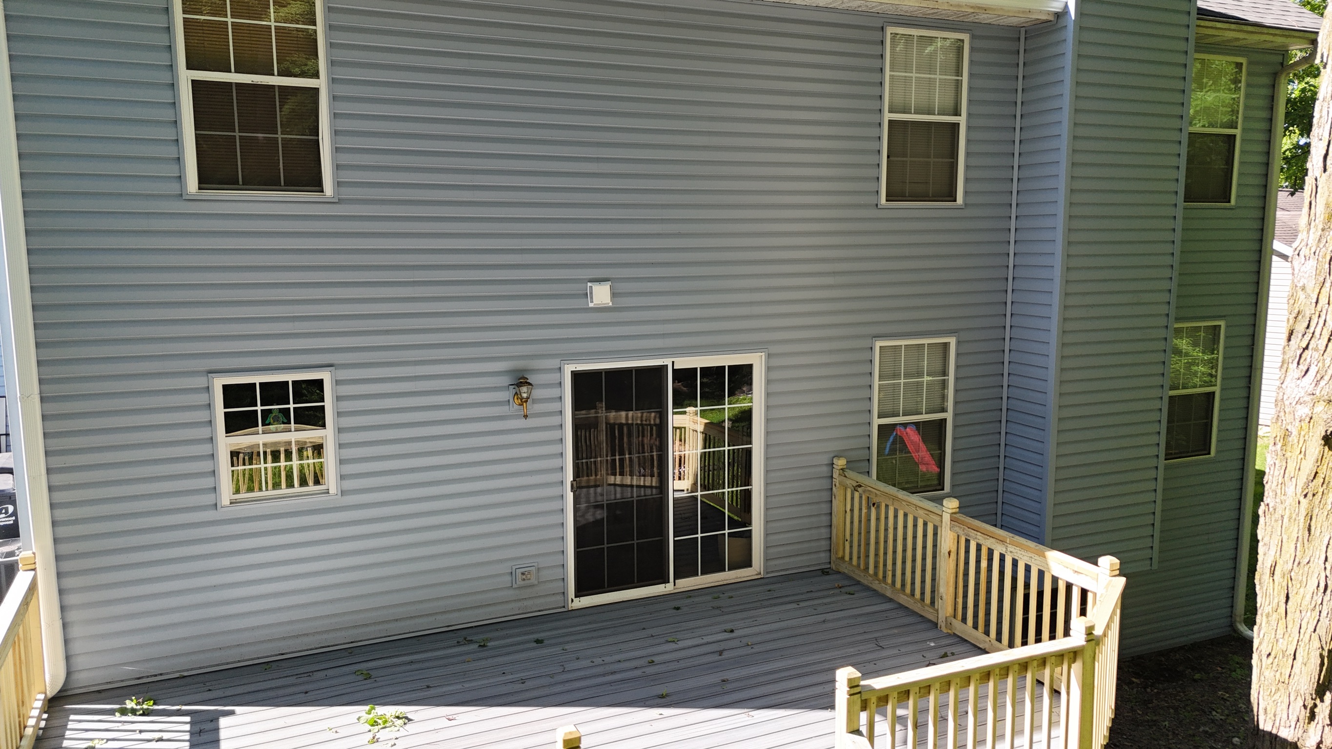 Completed residential roofing service with gray architectural shingles.