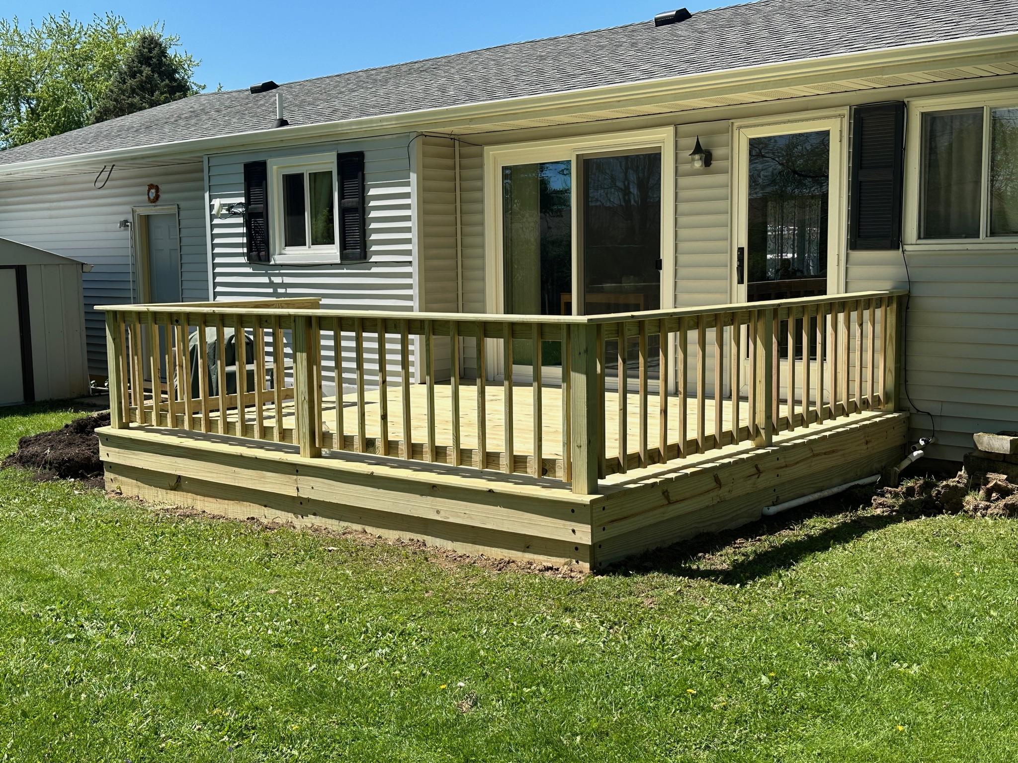 New wood backyard deck and safety railing built by Precision Exterior Inc. for a residential home in the Lena, IL area.