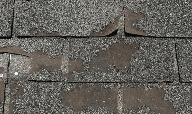 Close-up view of newly installed gray asphalt roofing shingles.