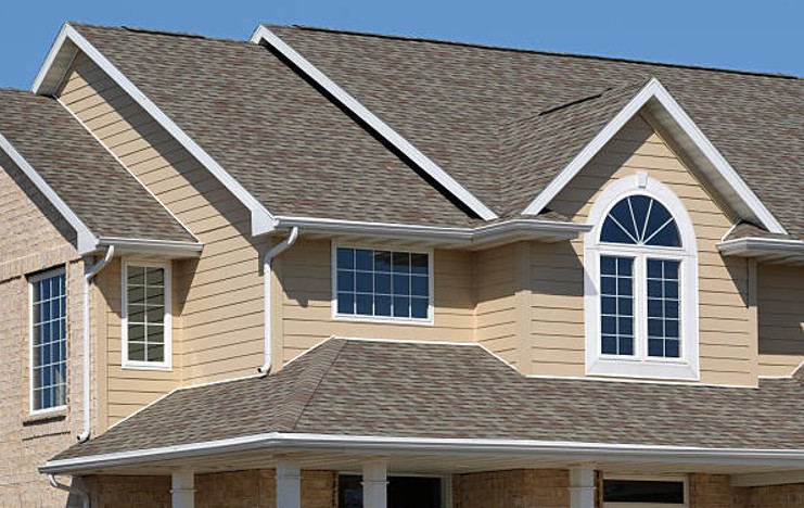 Completed architectural shingle roof installation on a two-story residential home by Precision Exteriors Inc. in Lena, IL.