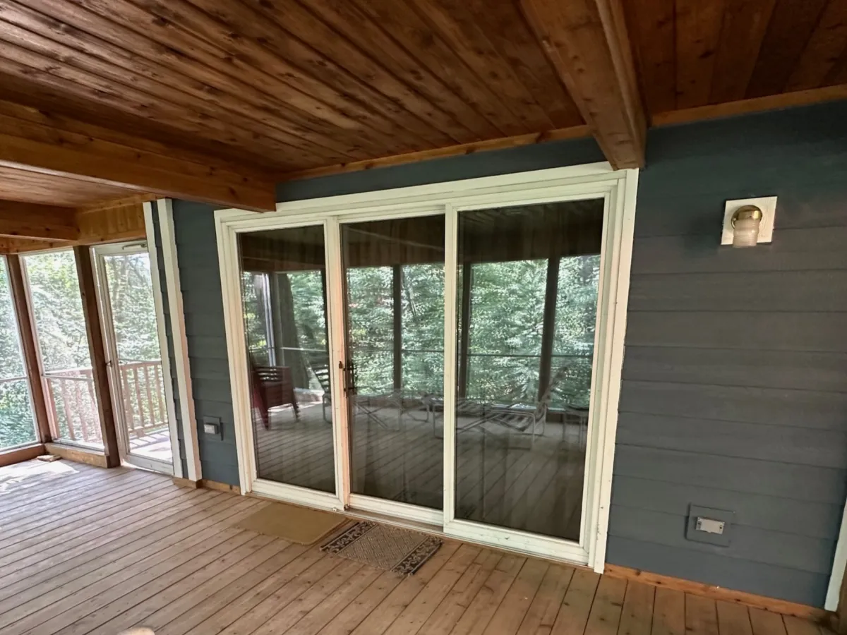 Technician installing large sliding glass window for energy efficient home improvement by Precision Exteriors Inc