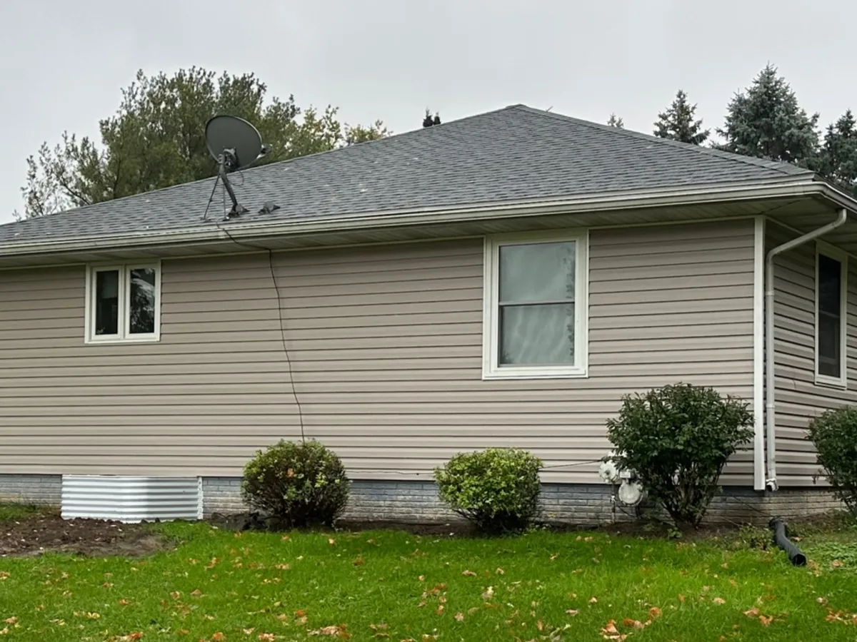 Professional siding installation on house exterior with vinyl siding by Precision Exteriors Inc