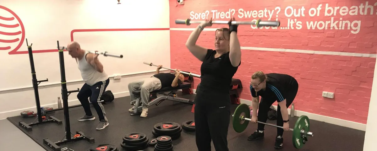 Four people practice yoga in a park.