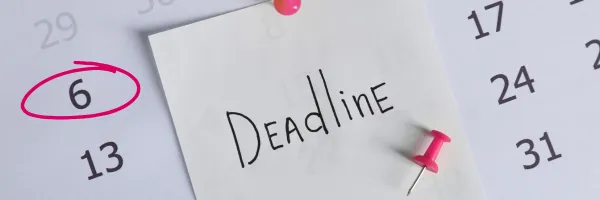 Calendar with written note on reading 'deadline', the 6th is circled in pink pen