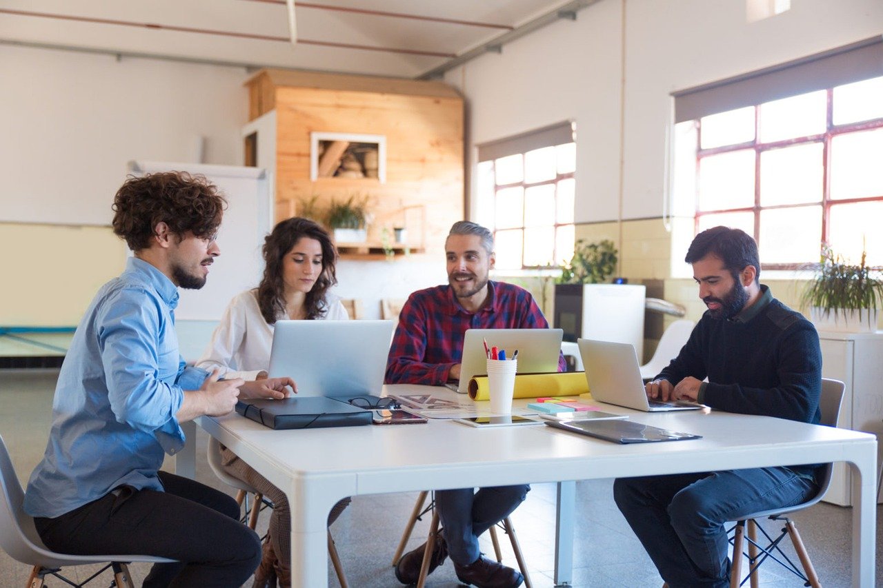 image of a team having a meeting discussing their numbers 