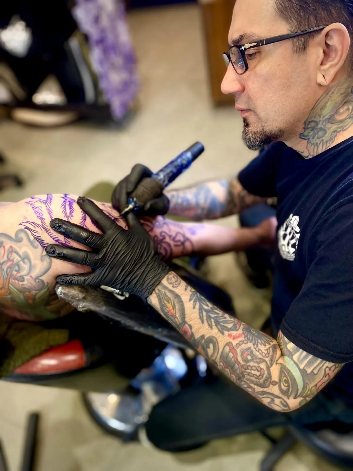 person in blue denim shorts and white nike sneakers standing on gray concrete floor