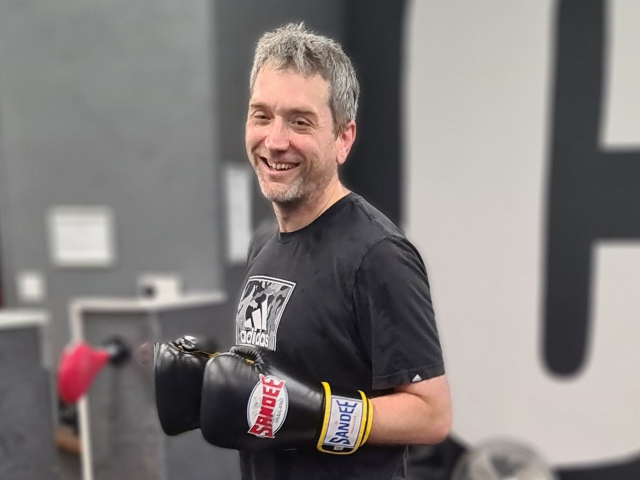 Kickboxing student after a training session, showing improved mood and focus