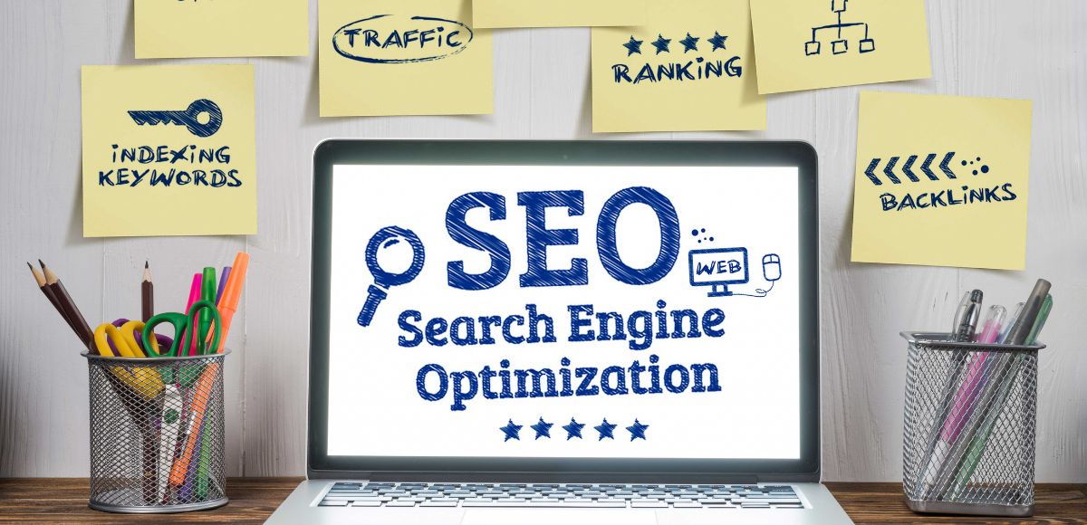 Website Optimization strategies at a work desk area and SEO on the laptop computer screen