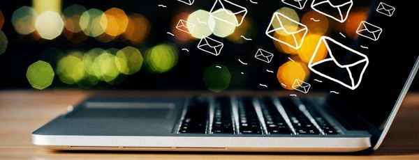 computer with mail icons representing healthcare newsletters